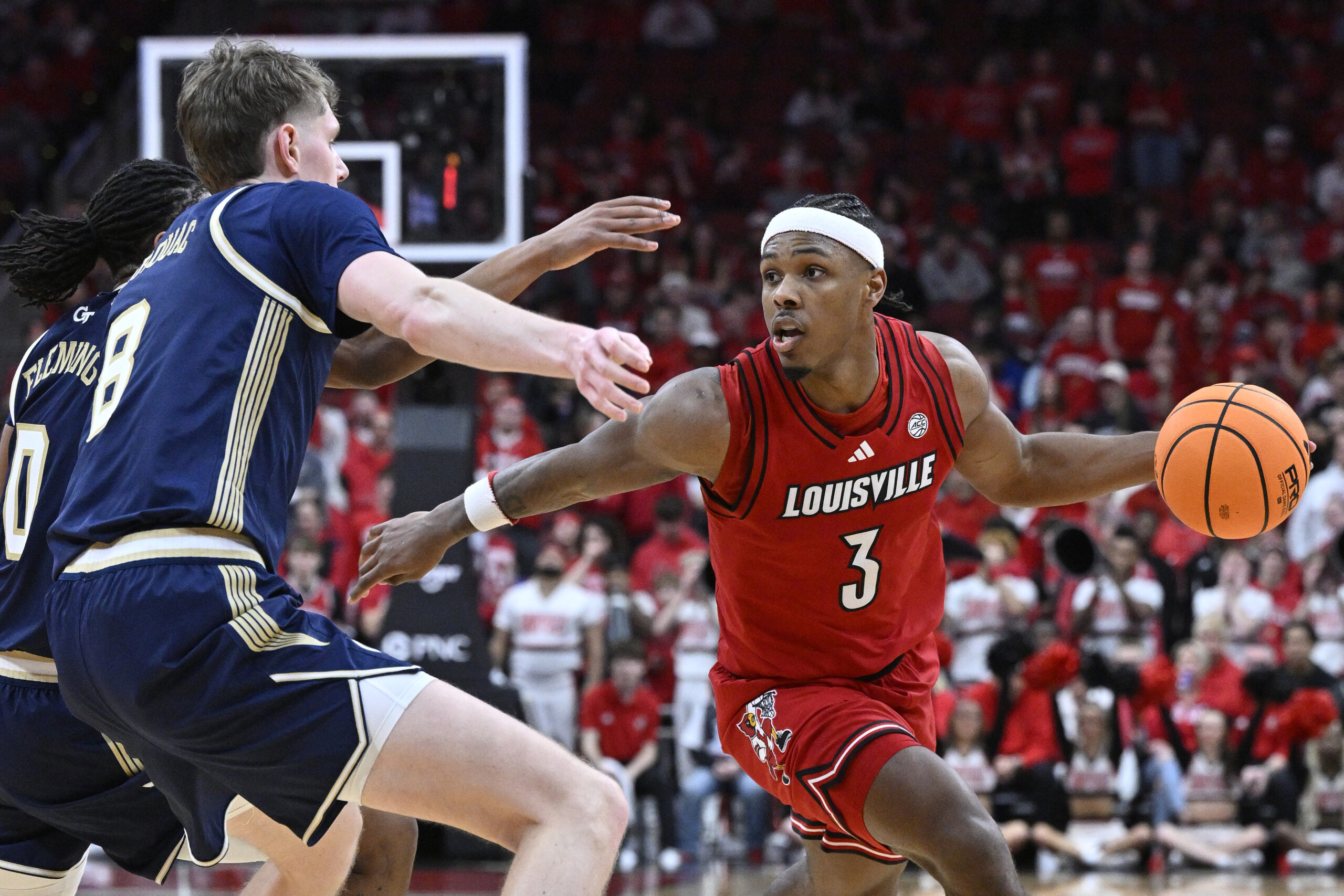 Feb 21, 2026; Louisville, Kentucky, USA; Louisville Cardinals guard Ryan Conwell (3) dribbles against Georgia Tech Yellow Jackets guard Akai Fleming (0) and center Cole Kirouac (8) during the second half at KFC Yum! Center. Louisville defeated Georgia Tech 87-70. Mandatory Credit: Jamie Rhodes-Imagn Images