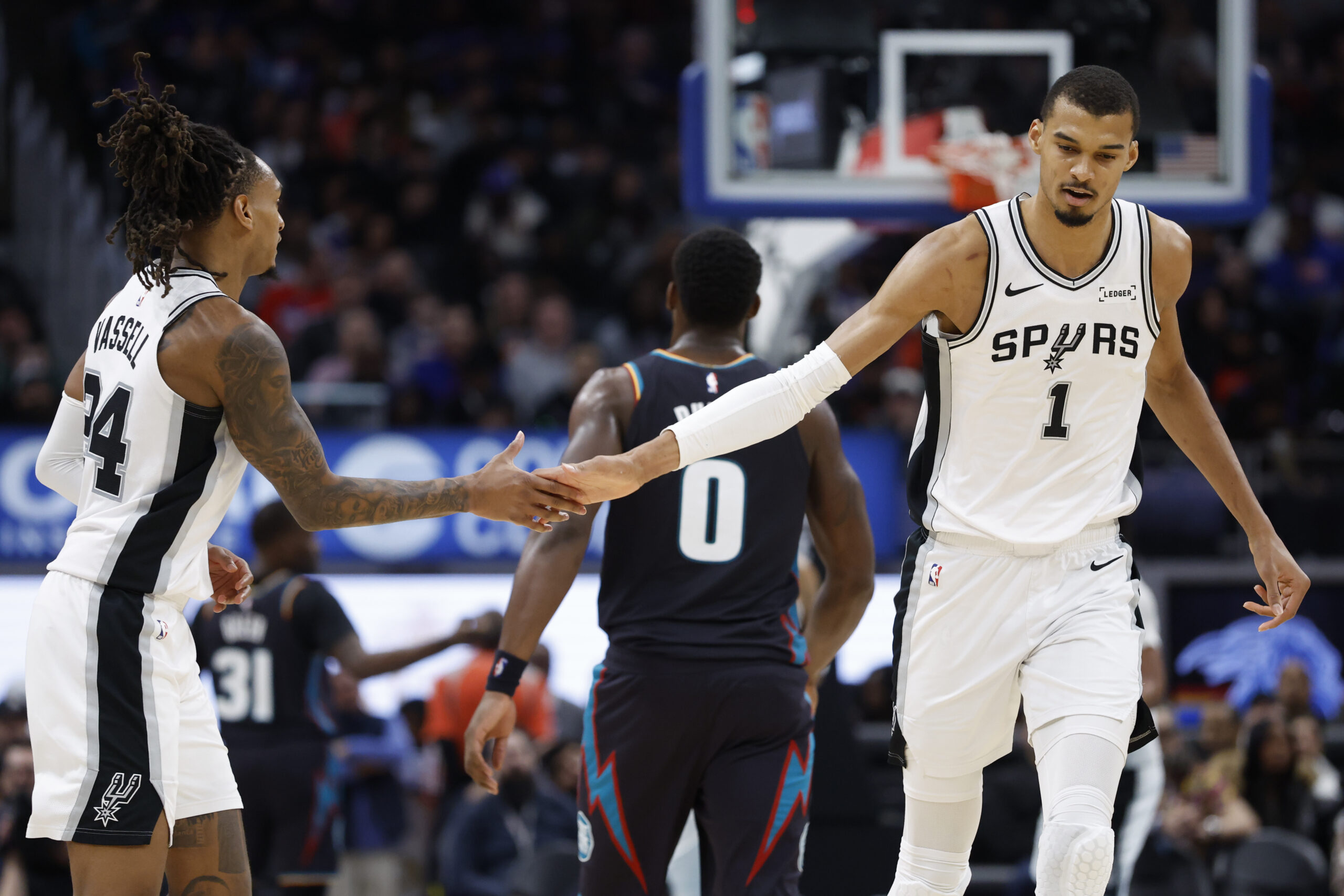 Feb 23, 2026; Detroit, Michigan, USA; San Antonio Spurs forward Victor Wembanyama (1) receives congratulations from guard Devin Vassell (24) in the second half against the Detroit Pistons at Little Caesars Arena. Mandatory Credit: Rick Osentoski-Imagn Images