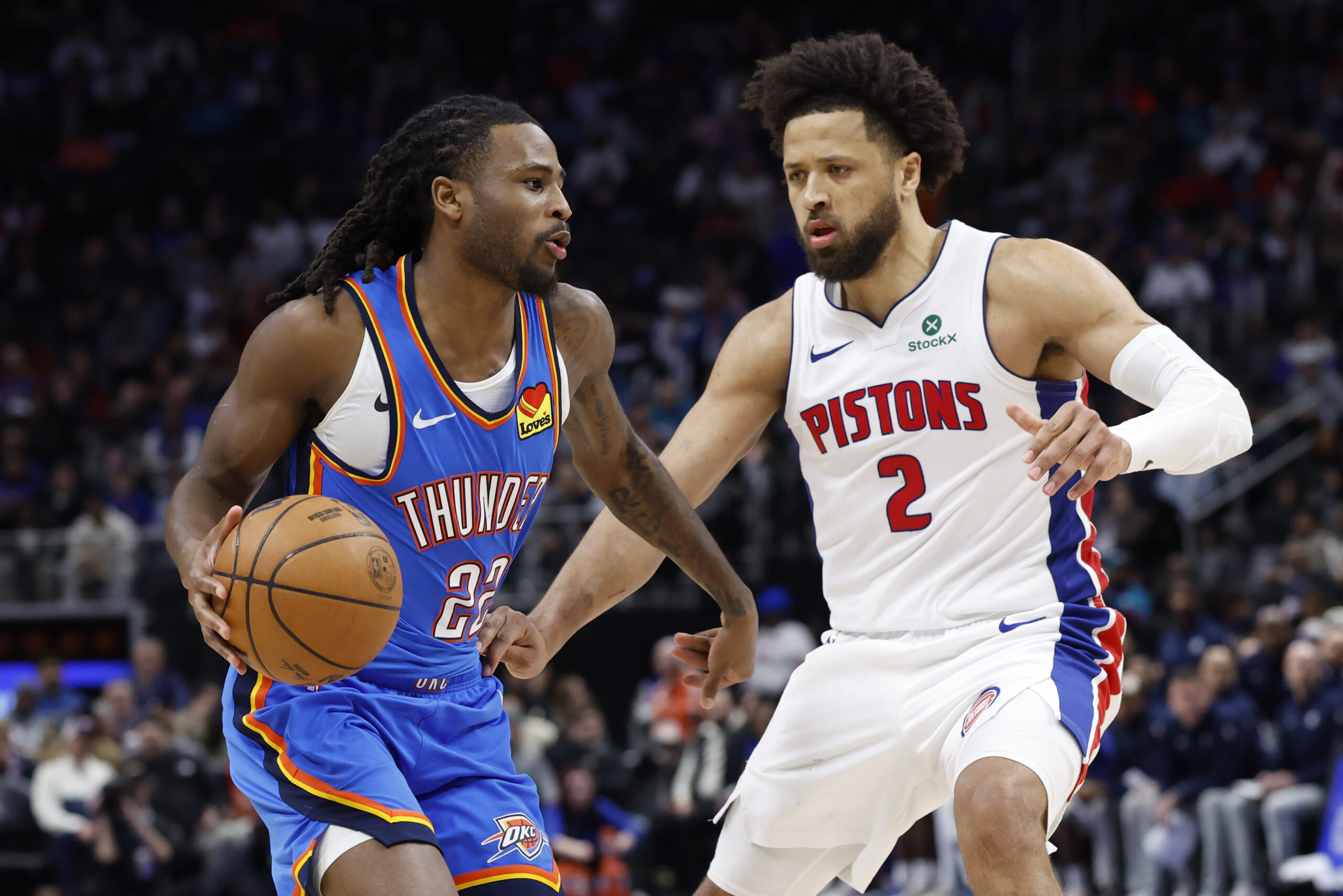 Feb 25, 2026; Detroit, Michigan, USA;  Oklahoma City Thunder guard Cason Wallace (22) dribbles defended by Detroit Pistons guard Cade Cunningham (2) in the second half at Little Caesars Arena. Mandatory Credit: Rick Osentoski-Imagn Images