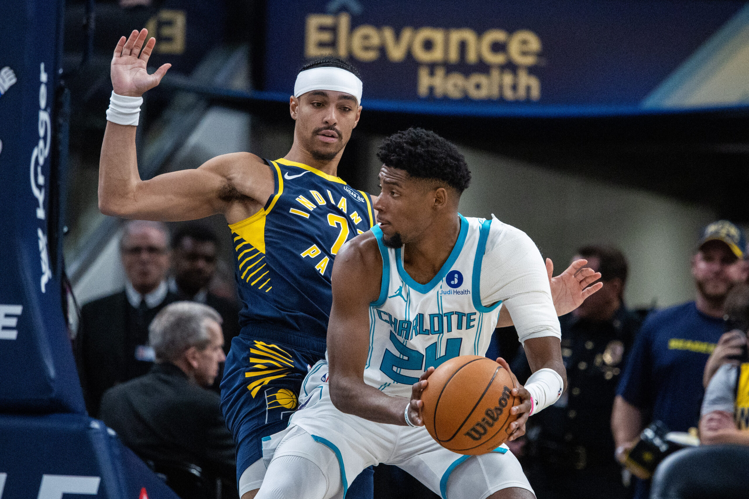 Feb 26, 2026; Indianapolis, Indiana, USA;  Charlotte Hornets forward Brandon Miller (24) holds the ball while  Indiana Pacers guard Andrew Nembhard (2) defends in the first half at Gainbridge Fieldhouse. Mandatory Credit: Trevor Ruszkowski-Imagn Images
