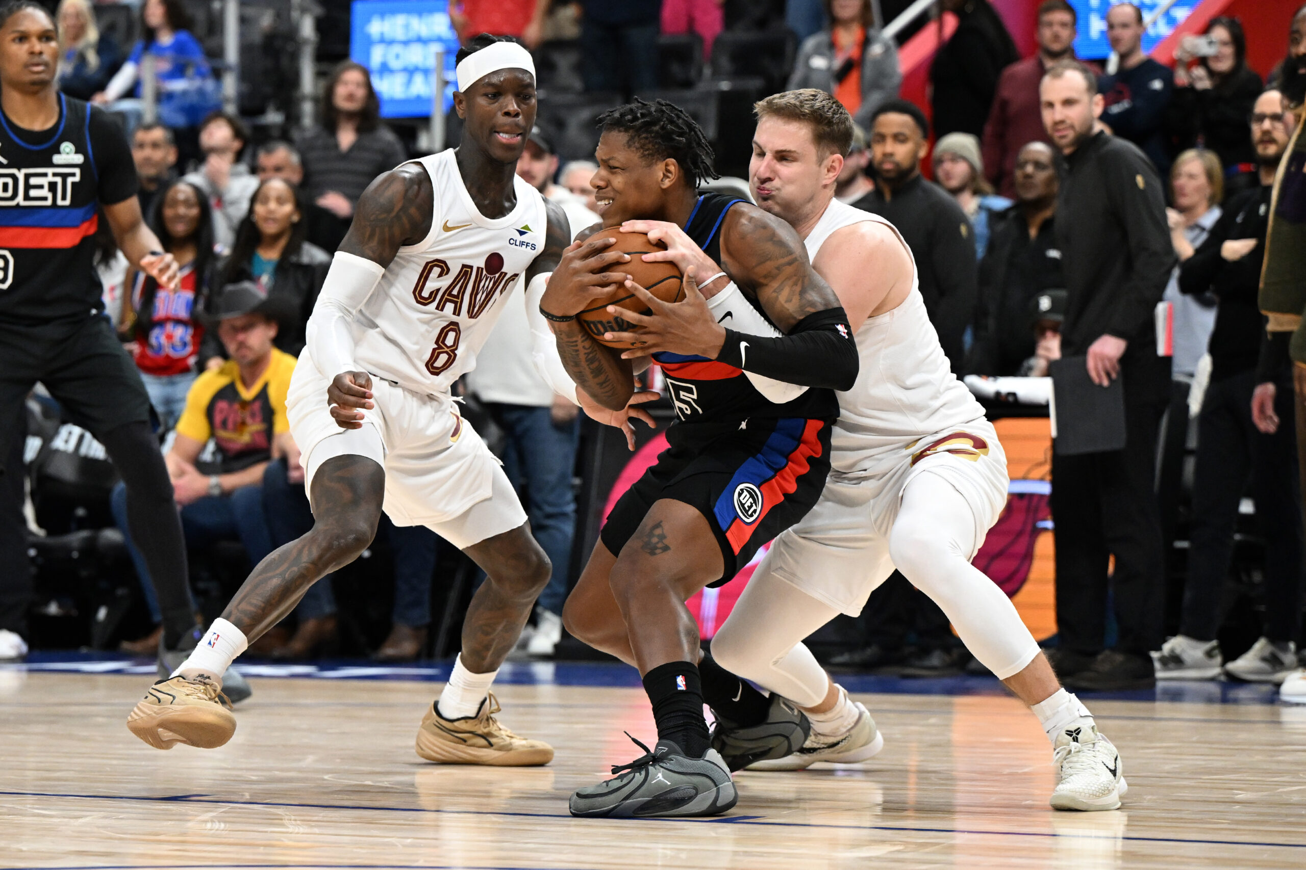 Feb 27, 2026; Detroit, Michigan, USA;  Cleveland Cavaliers guard Sam Merrill (5) ties up Detroit Pistons guard Marcus Sasser (25) for a jump ball as Cleveland Cavaliers guard Dennis Schroder (8) looks on in overtime at Little Caesars Arena. Mandatory Credit: Lon Horwedel-Imagn Images