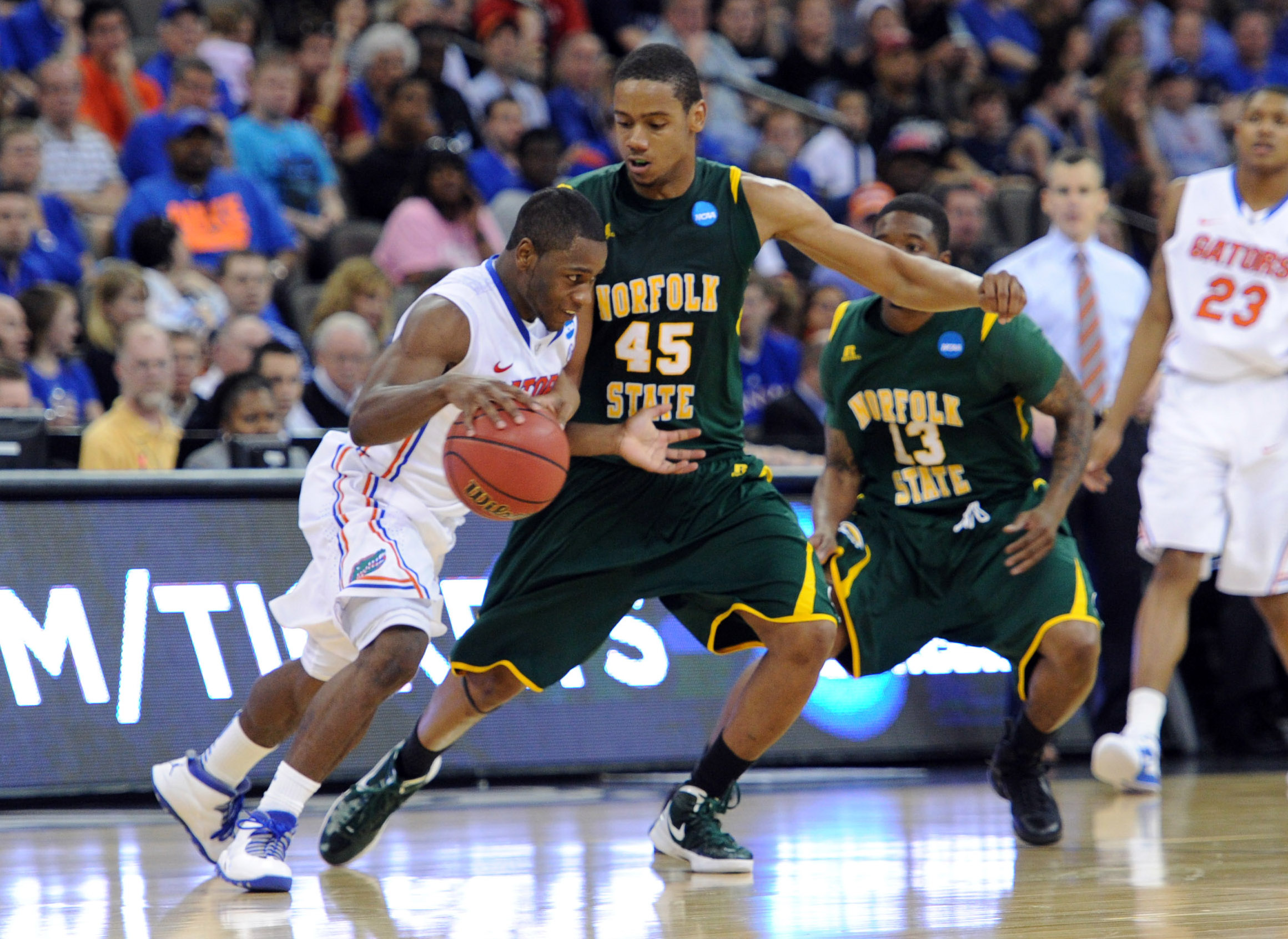 Mar 18, 2012; Omaha, NE, USA; Florida Gators guard Erving Walker (11) drives against Norfolk State Spartans forward A.J. Rogers (45) during the second half in the third round of the 2012 NCAA men's basketball tournament at the CenturyLink Center.  Florida defeated Norfolk State 84-50.  Mandatory Credit: Peter G. Aiken-Imagn Images