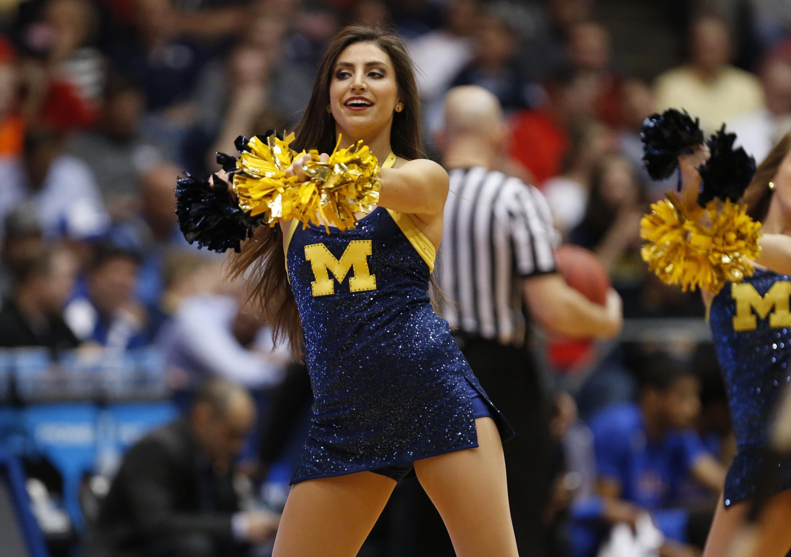 Mar 16, 2016; Dayton, OH, USA; Michigan Wolverines cheerleader performs during the first half against the Tulsa Golden Hurricane in the First Four of the NCAA men's college basketball tournament at Dayton Arena. Mandatory Credit: Rick Osentoski-Imagn Images