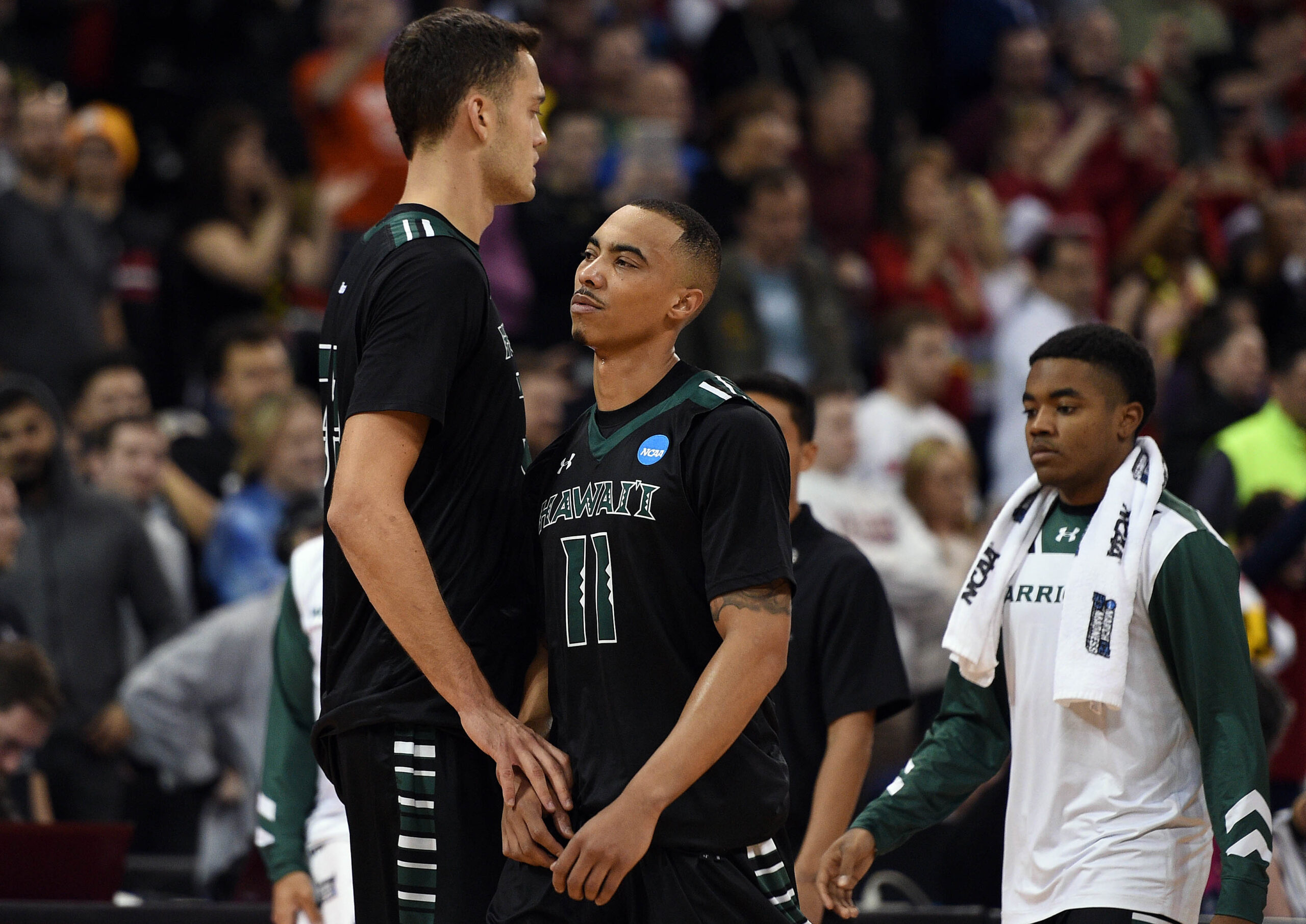 March 20, 2016; Spokane , WA, USA; Hawaii Rainbow Warriors forward Stefan Jankovic (33) and guard Quincy Smith (11) react following the 73-60 loss against Maryland Terrapins in the second round of the 2016 NCAA Tournament at Spokane Veterans Memorial Arena. Mandatory Credit: Kyle Terada-Imagn Images