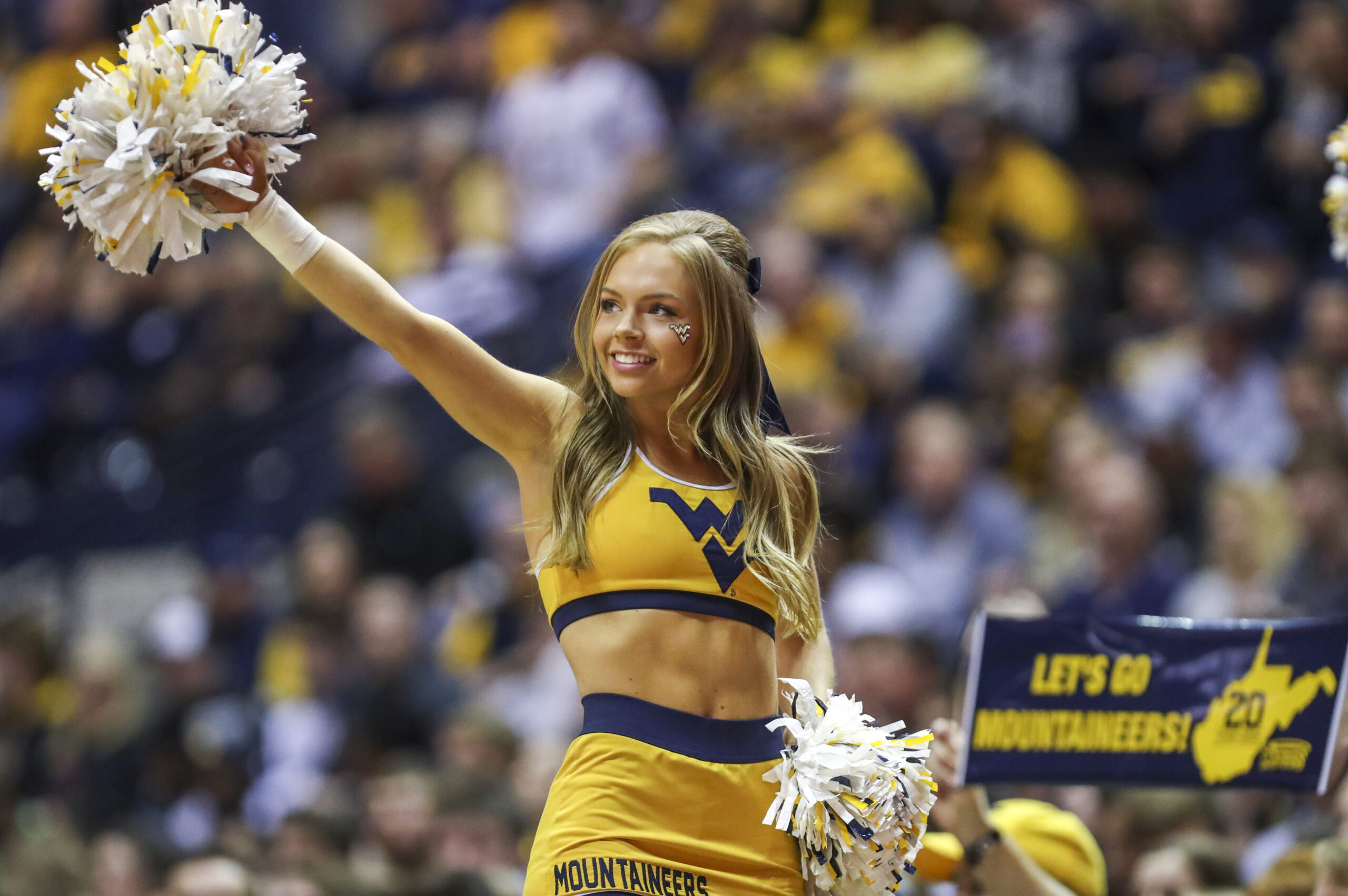 Mar 7, 2020; Morgantown, West Virginia, USA; A West Virginia Mountaineers cheerleader performs during the first half against the Baylor Bears at WVU Coliseum. Mandatory Credit: Ben Queen-Imagn Images