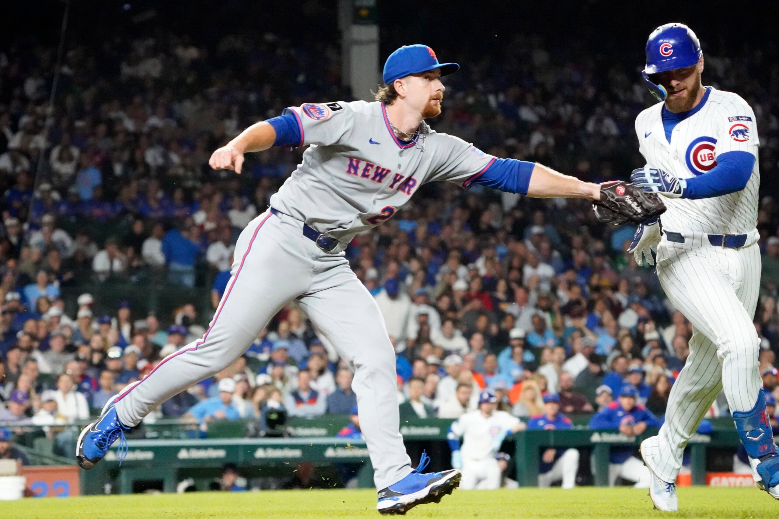 Sep 25, 2025; Chicago, Illinois, USA; New York Mets pitcher Nolan McLean (26) tags out Chicago Cubs first base Michael Busch (29) during the fifth inning at Wrigley Field. Mandatory Credit: David Banks-Imagn Images