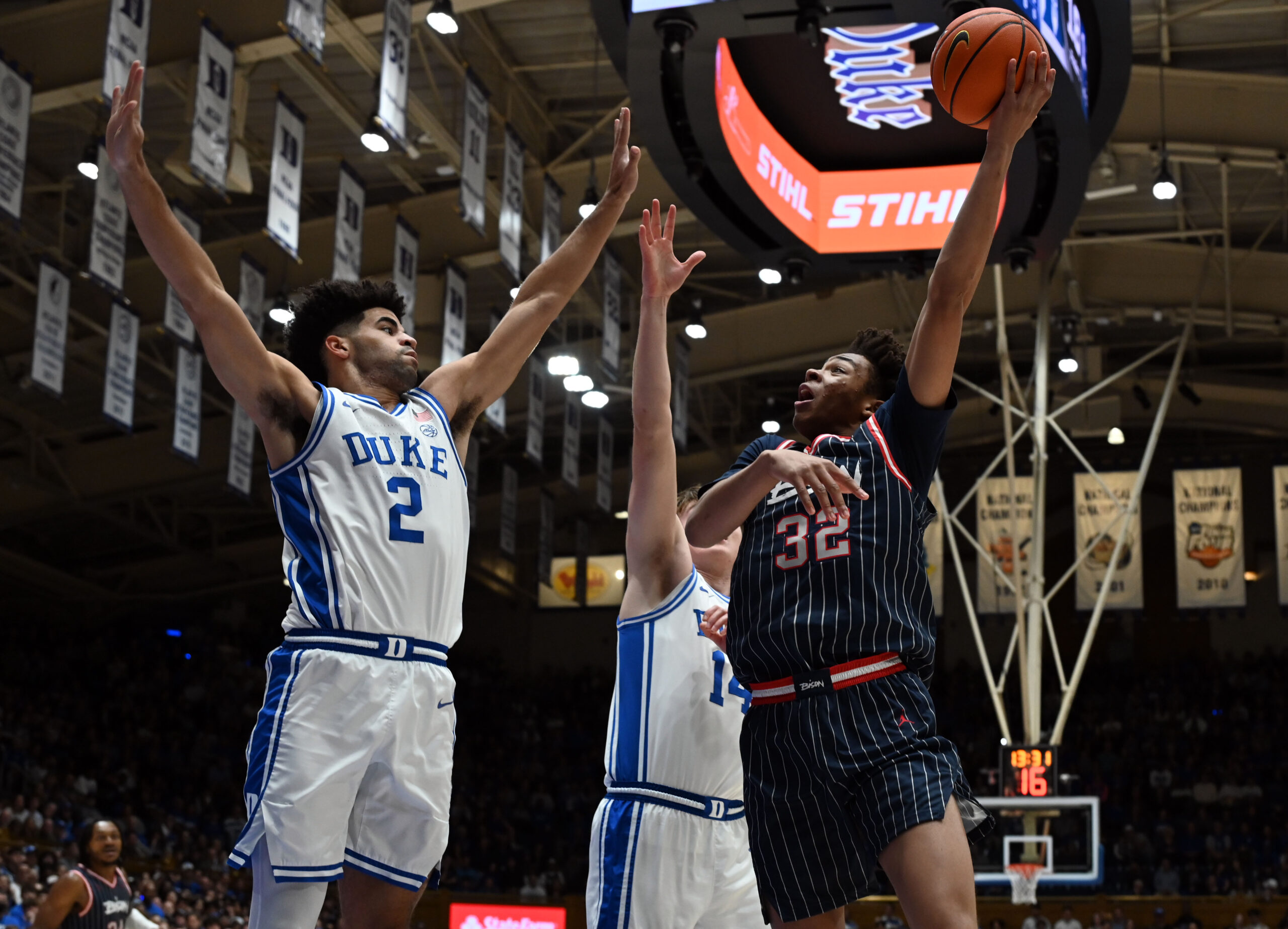 Nov 23, 2025; Durham, North Carolina, USA;  Howard Bison forward Travelle Bryson (32) shoots the ball over Duke Blue Devils guard Cayden Boozer (2) during the first half at Cameron Indoor Stadium. Mandatory Credit: Rob Kinnan-Imagn Images