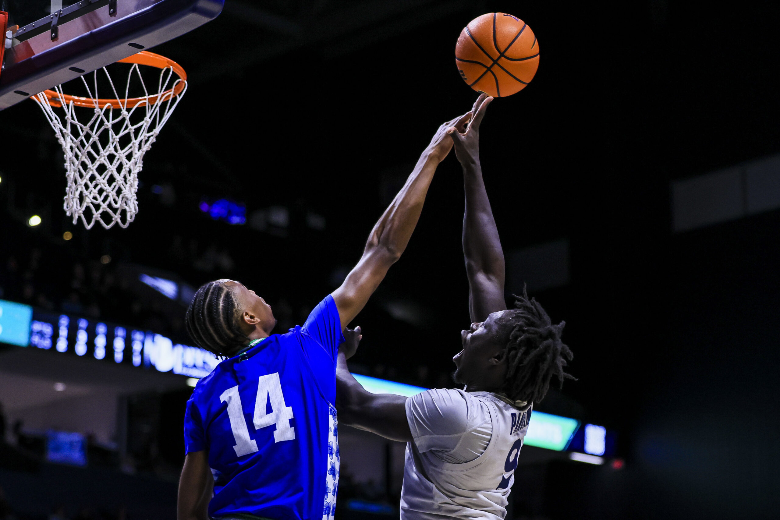 Nov 28, 2025; Cincinnati, Ohio, USA; Texas A&M-Corpus Christi Islanders guard Cedric Horton (14) blocks a shot by Xavier Musketeers guard Mier Panoam (9) in the second half at Cintas Center. Mandatory Credit: Katie Stratman-Imagn Images