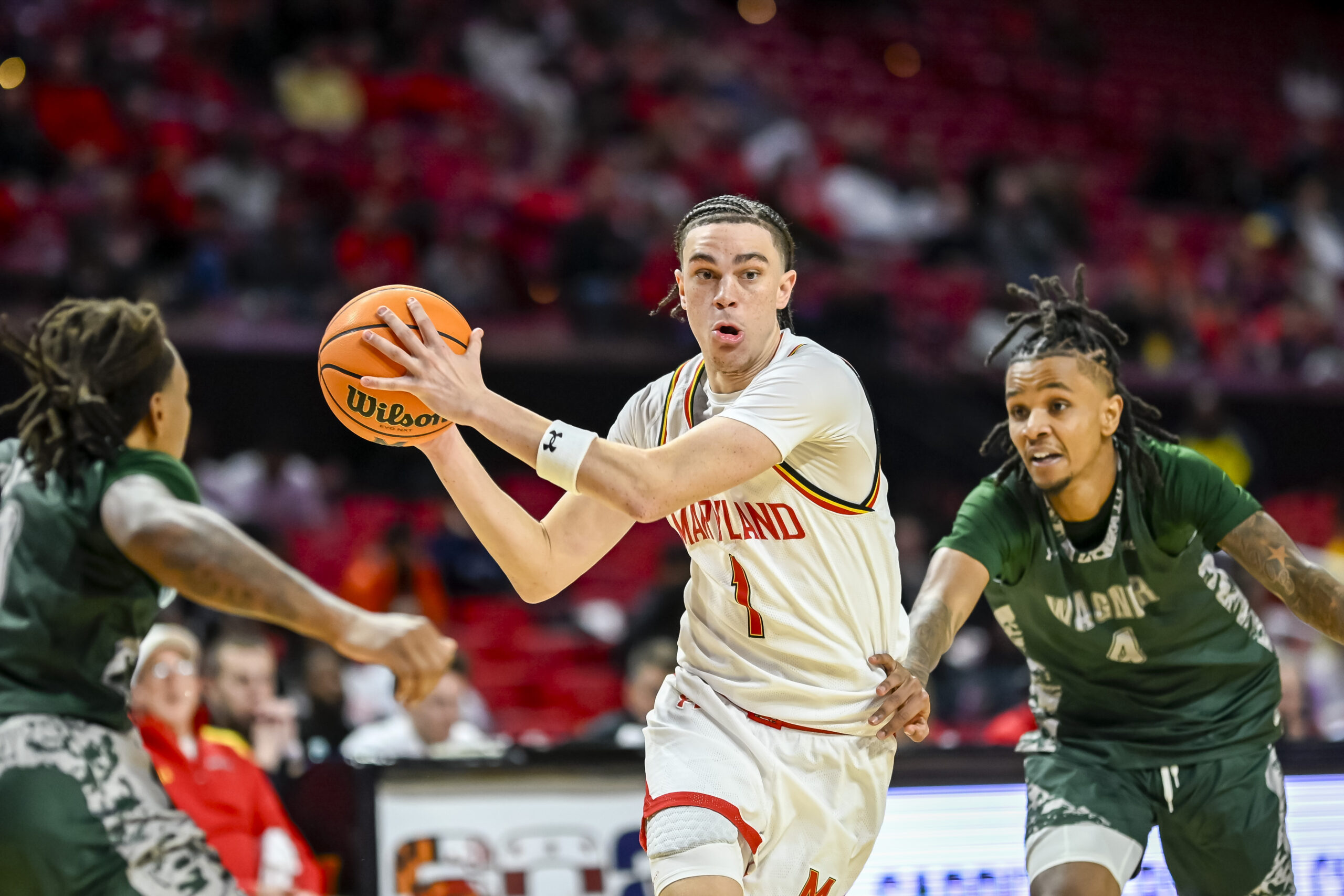 Dec 2, 2025; College Park, Maryland, USA;  Maryland Terrapins guard Darius Adams (1) makes a move to the basket on Wagner Seahawks guard John Awoke (4) during the second half at Xfinity Center. Mandatory Credit: Tommy Gilligan-Imagn Images