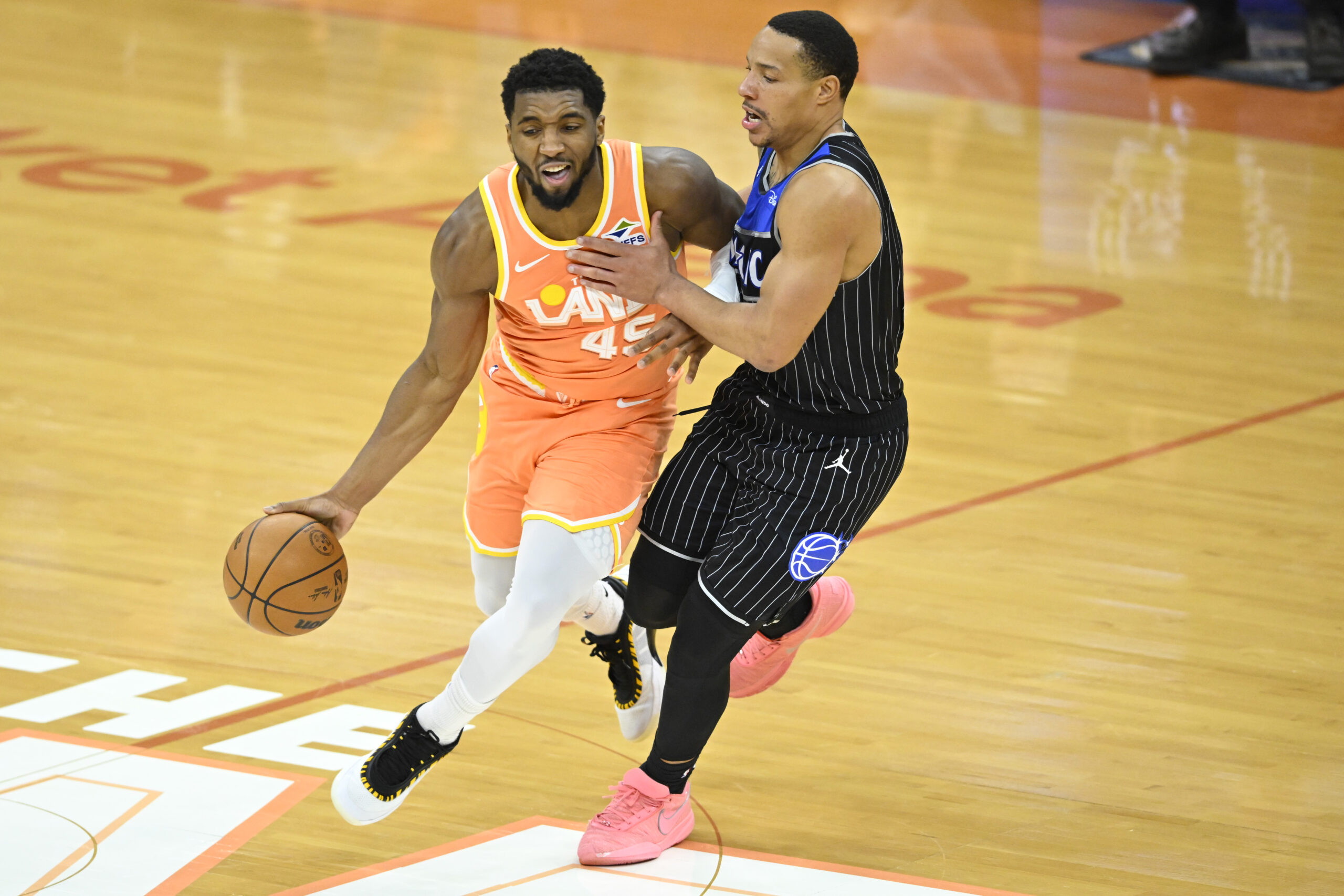 Jan 26, 2026; Cleveland, Ohio, USA; Cleveland Cavaliers guard Donovan Mitchell (45) dribbles beside Orlando Magic guard Desmond Bane (3) in the fourth quarter at Rocket Arena. Mandatory Credit: David Richard-Imagn Images