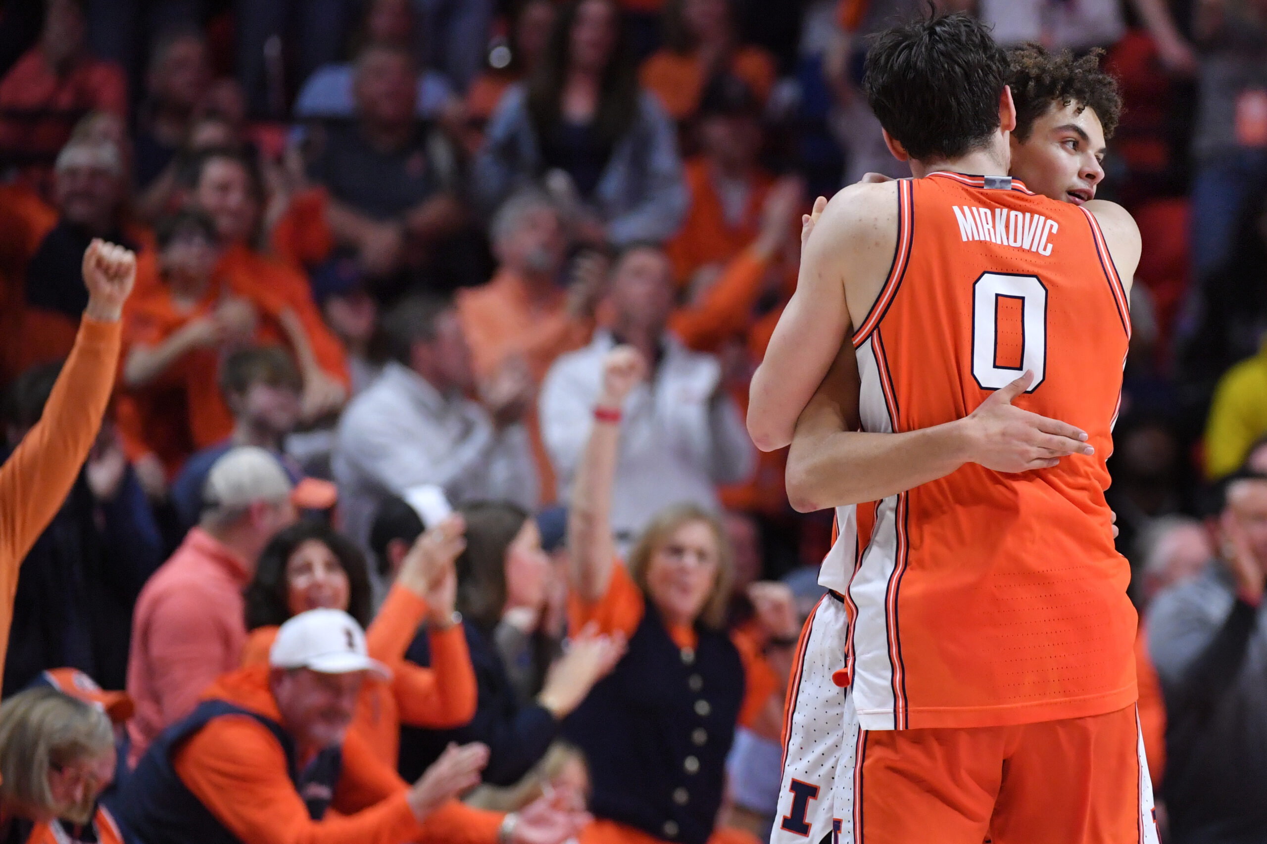 Feb 27, 2026; Champaign, Illinois, USA; Illinois Fighting Illini forward David Mirkovic (0) embraces Illinois Fighting Illini guard Keaton Wagler (23) after a score during the second half against the Michigan Wolverines at State Farm Center. Mandatory Credit: Ron Johnson-Imagn Images