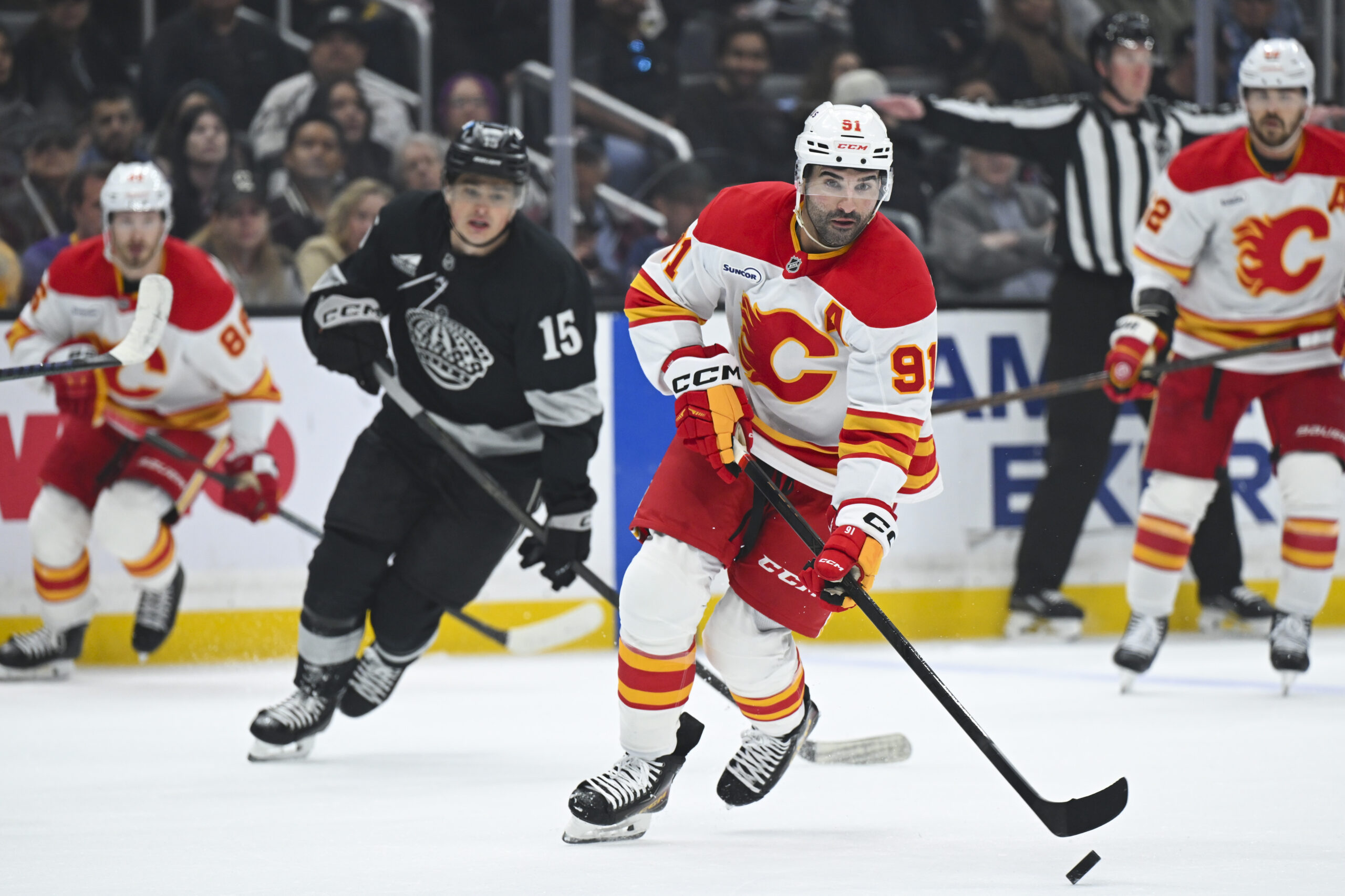 Feb 28, 2026; Los Angeles, California, USA; Calgary Flames center Nazem Kadri (91) skates with the puck during the first period against the Los Angeles Kings at Crypto.com Arena. Mandatory Credit: Griffin Hooper-Imagn Images