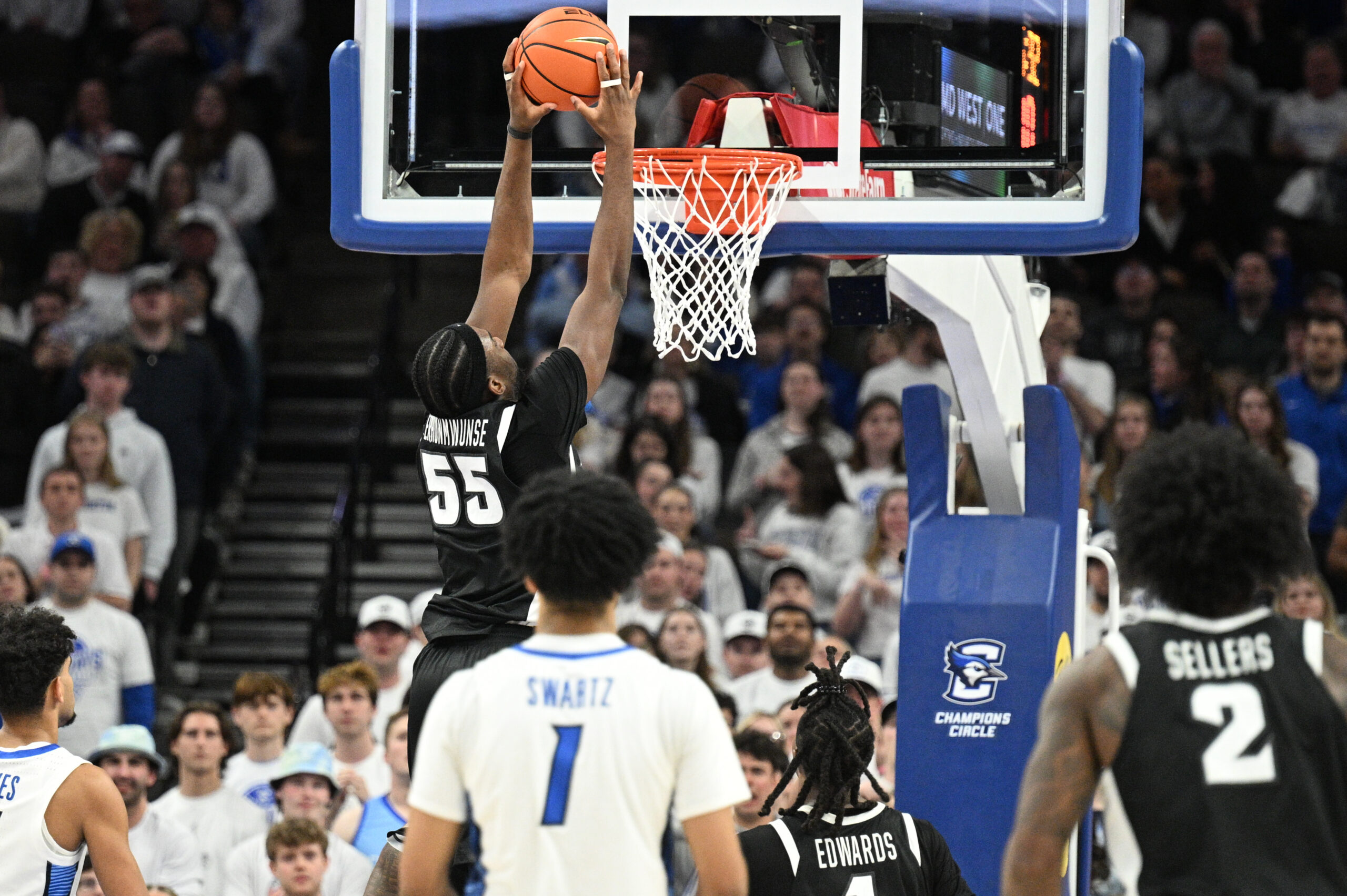 Feb 28, 2026; Omaha, Nebraska, USA; Providence Friars forward Oswin Erhunmwunse (55) dunks against the Creighton Bluejays during the second half at CHI Health Center Omaha. Mandatory Credit: Steven Branscombe-Imagn Images