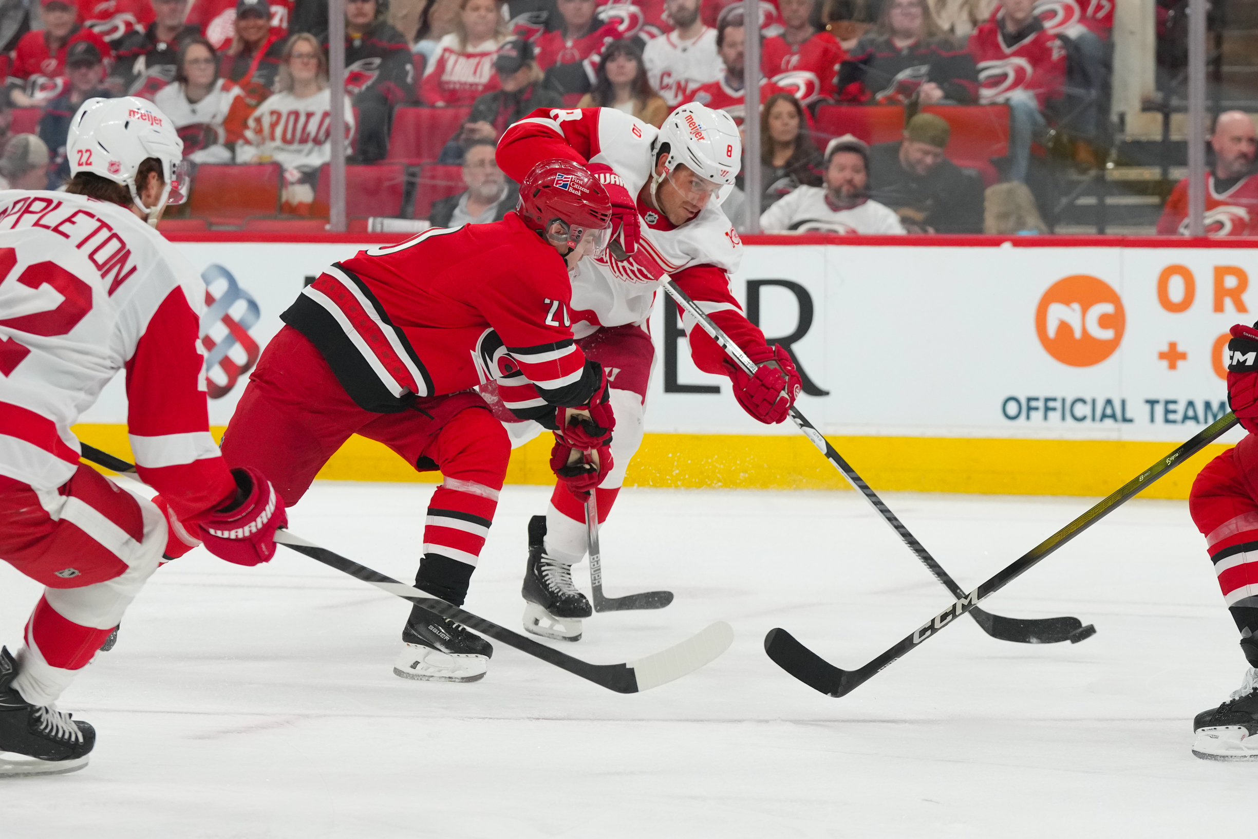 Feb 28, 2026; Raleigh, North Carolina, USA;  Detroit Red Wings defenseman Ben Chiarot (8) gets the shot away against Carolina Hurricanes center Sebastian Aho (20) during the second period at Lenovo Center. Mandatory Credit: James Guillory-Imagn Images