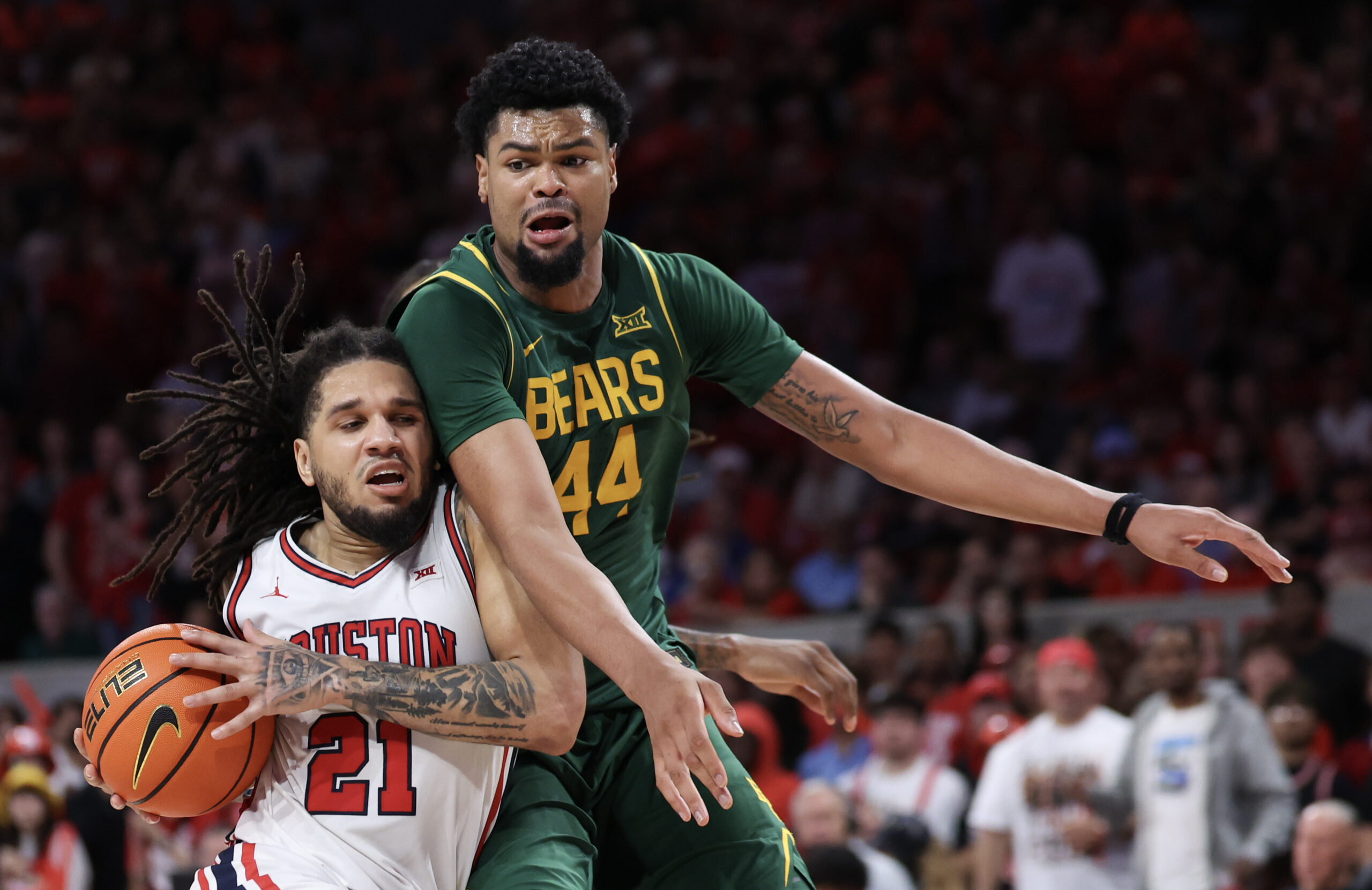 Mar 4, 2026; Houston, Texas, USA; Houston Cougars guard Emanuel Sharp (21) drives to the basket against Baylor Bears center Caden Powell (44) in the second half at Fertitta Center. Mandatory Credit: Thomas Shea-Imagn Images