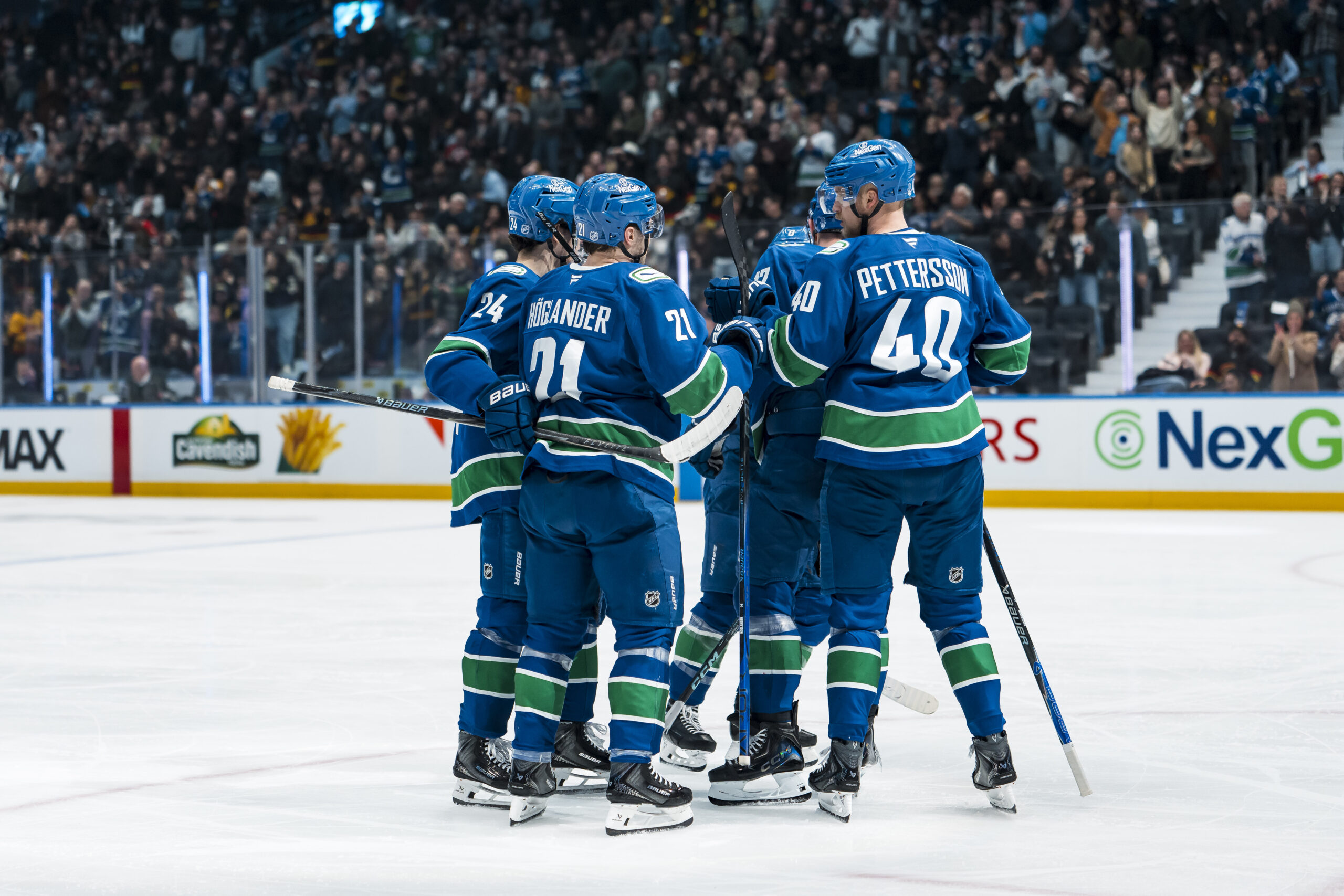 Mar 4, 2026; Vancouver, British Columbia, CAN; Vancouver Canucks defenseman Zeev Buium (24) and forward Nils Hoglander (21) and defenseman Filip Hronek (17) and forward Elias Pettersson (40) celebrate Hoglander’s goal against the Carolina Hurricanes in the third period at Rogers Arena. Mandatory Credit: Bob Frid-Imagn Images