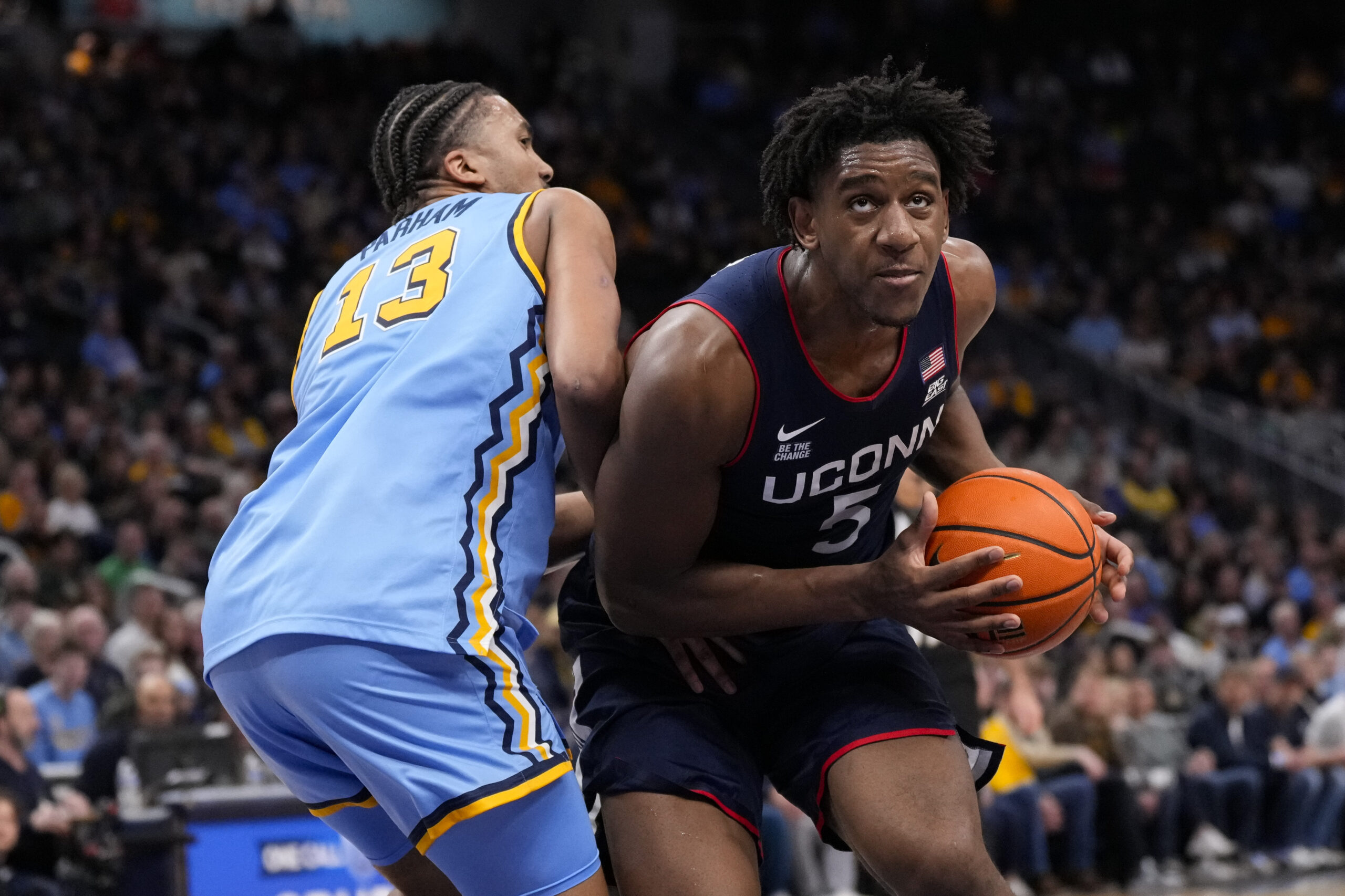 Mar 7, 2026; Milwaukee, Wisconsin, USA;  Connecticut Huskies center Tarris Reed Jr. (5) looks to shoot against Marquette Golden Eagles forward Royce Parham (13) during the first half at Fiserv Forum. Mandatory Credit: Jeff Hanisch-Imagn Images