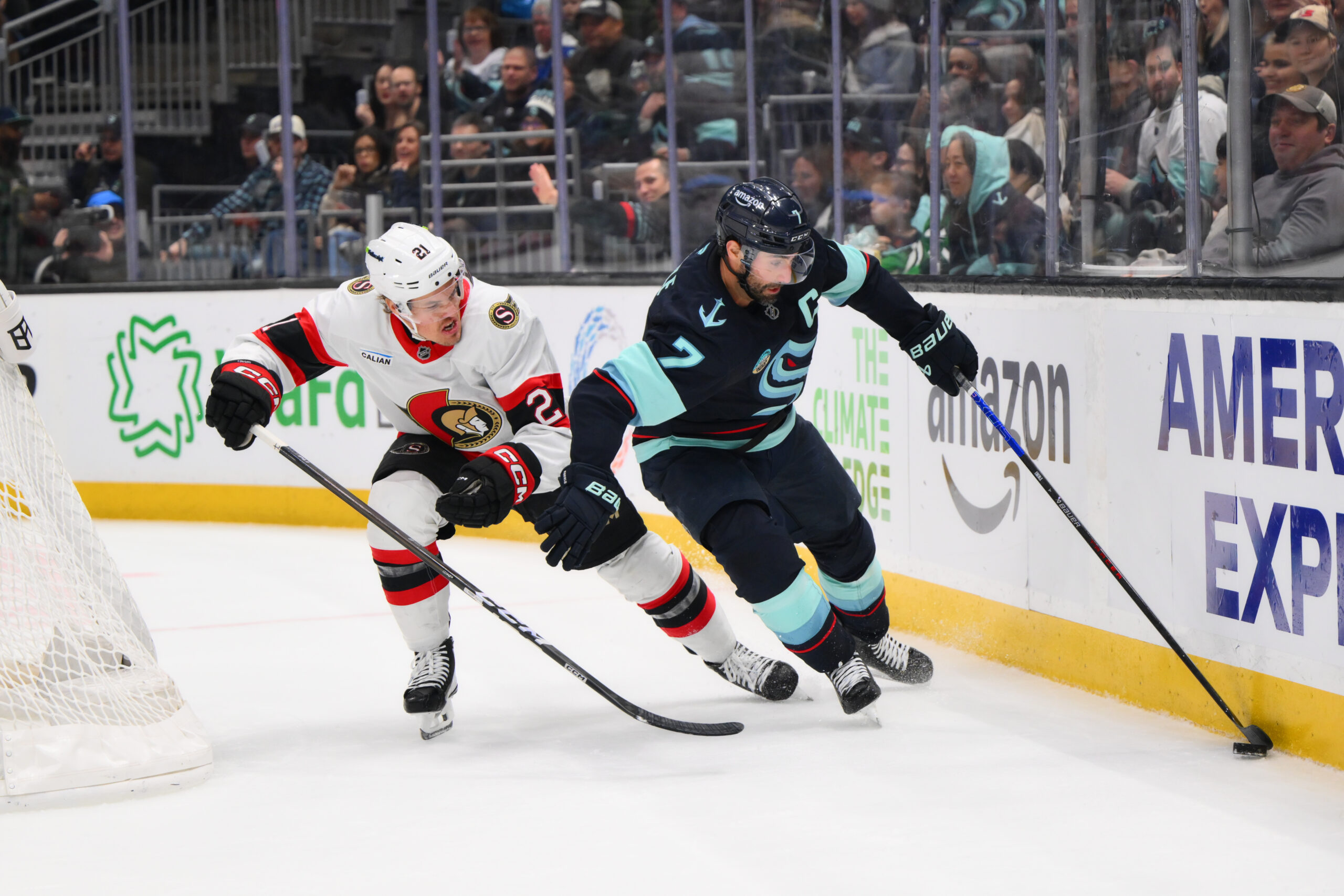 Mar 7, 2026; Seattle, Washington, USA; Seattle Kraken right wing Jordan Eberle (7) plays the puck while defended by Ottawa Senators defenseman Artem Zub (2) during the second period at Climate Pledge Arena. Mandatory Credit: Steven Bisig-Imagn Images