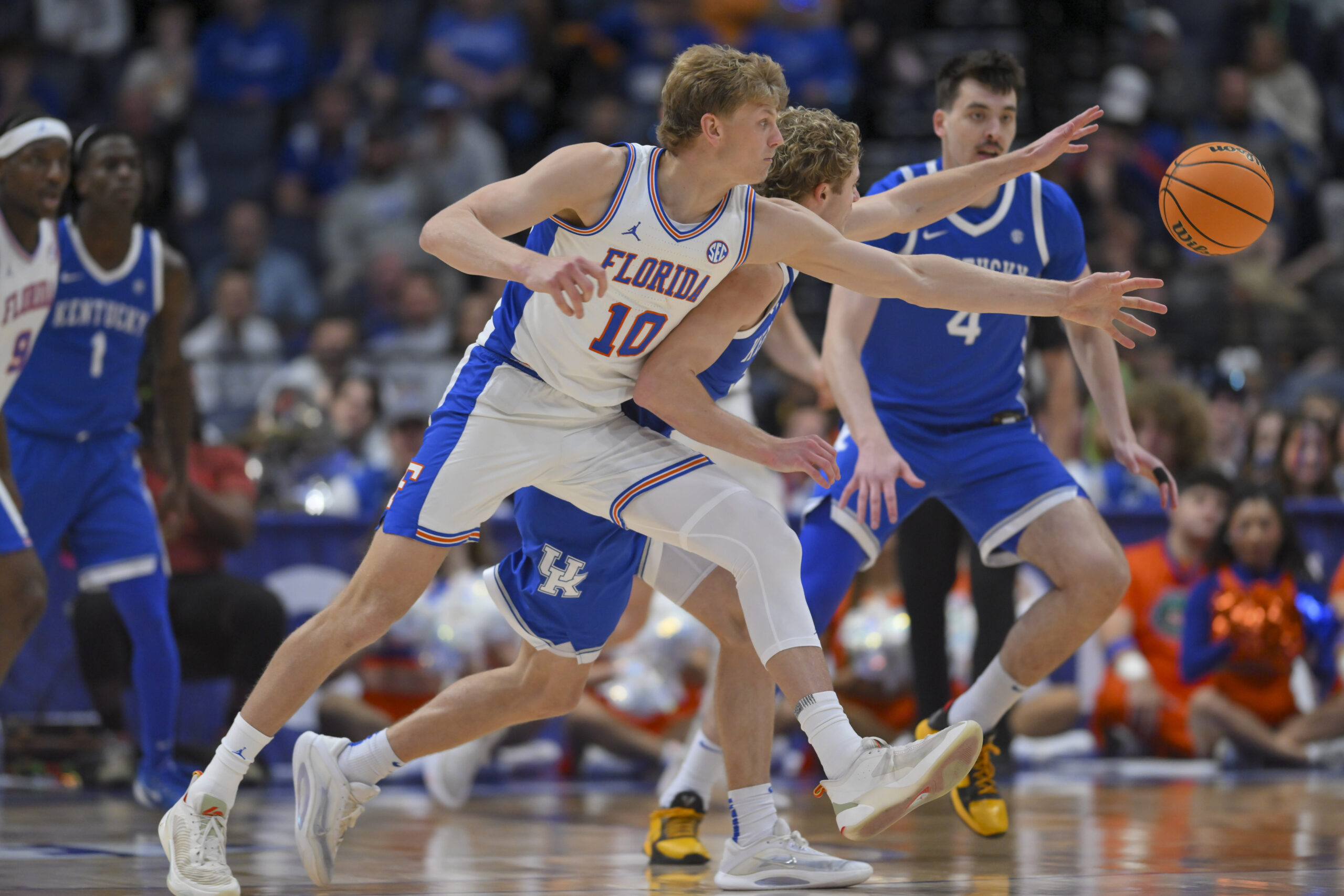 Mar 13, 2026; Nashville, TN, USA;  Florida Gators forward Thomas Haugh (10) and Kentucky Wildcats guard Collin Chandler (5) fight for the loose ball during the second half at Bridgestone Arena. Mandatory Credit: Steve Roberts-Imagn Images