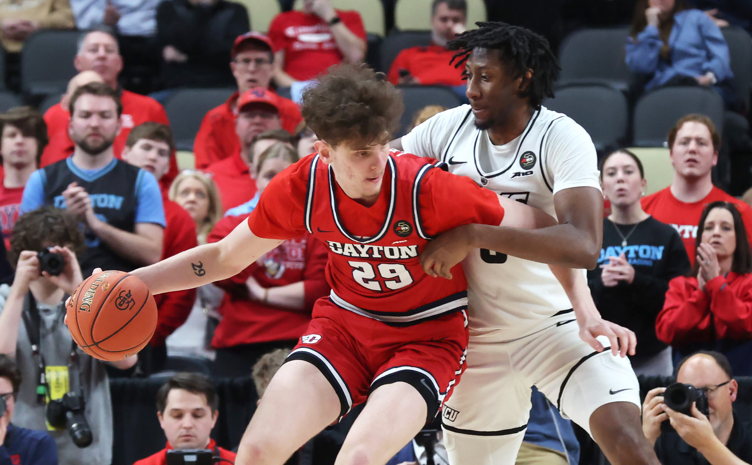 Mar 15, 2026; Pittsburgh, PA, USA;  Dayton Flyers forward Amael L'etang (29) dribbles while closely guarded by VCU Rams forward Michael Belle (right) during the second half in the Atlantic 10 Conference Tournament Championship game at PPG Paints Arena. Mandatory Credit: Charles LeClaire-Imagn Images