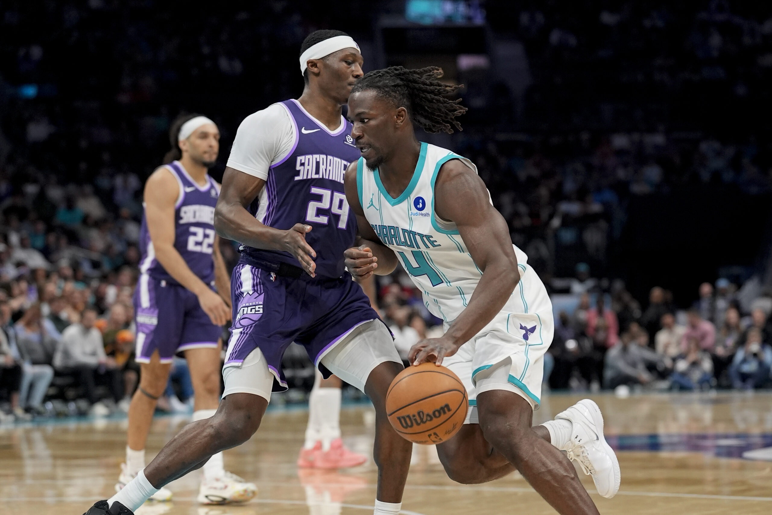 Mar 24, 2026; Charlotte, North Carolina, USA; Charlotte Hornets guard Sion James (4) moves the ball against Sacramento Kings guard/forward Daeqwon Plowden (29) during the second half at Spectrum Center. Mandatory Credit: Jim Dedmon-Imagn Images