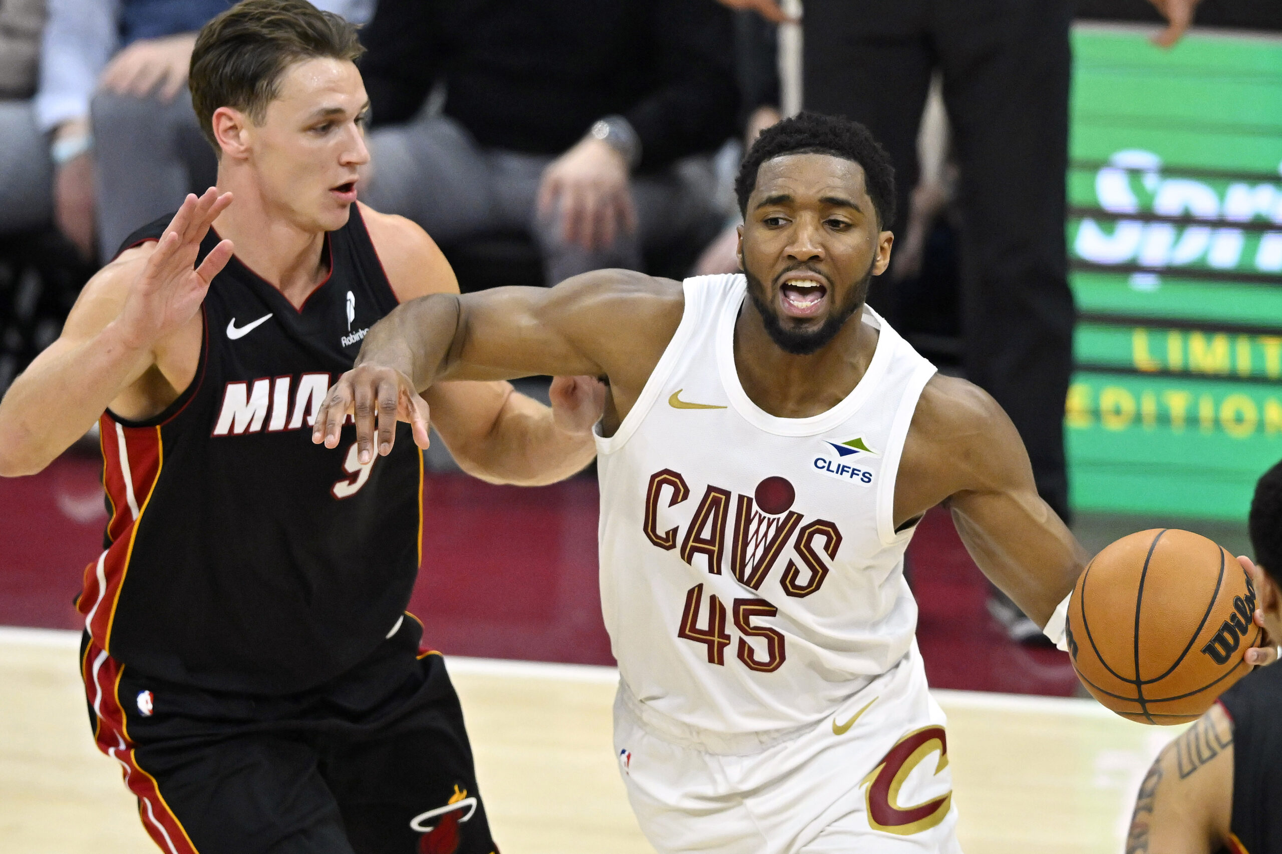 Mar 25, 2026; Cleveland, Ohio, USA; Miami Heat guard Pelle Larsson (9) defends Cleveland Cavaliers guard Donovan Mitchell (45) in the fourth quarter at Rocket Arena. Mandatory Credit: David Richard-Imagn Images