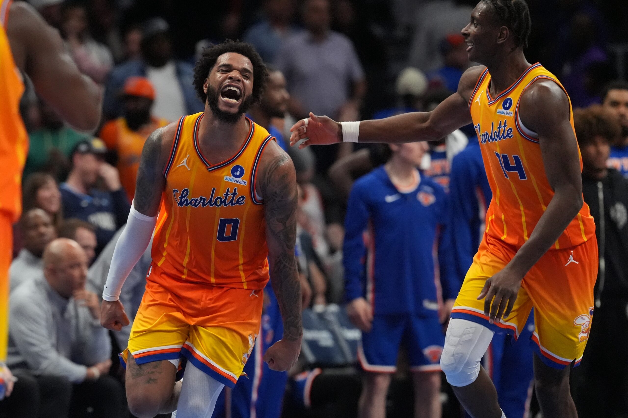 Mar 26, 2026; Charlotte, North Carolina, USA;  Charlotte Hornets forward Miles Bridges (0) and forward Moussa Diabaté (14) react after a score against the New York Knicks during the second half at the Spectrum Center. Mandatory Credit: Jim Dedmon-Imagn Images