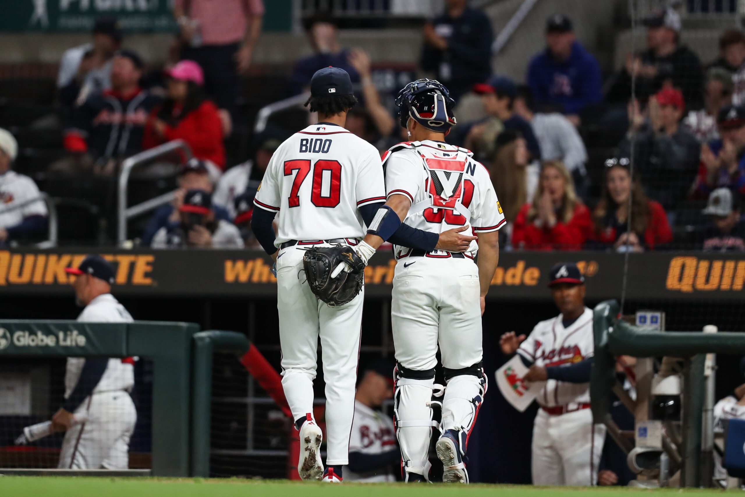 Mar 28, 2026; Cumberland, Georgia, USA; Atlanta Braves relief pitcher Osvaldo Bido (70) and Atlanta Braves catcher Drake Baldwin (30) walk off the field against the Kansas City Royals in the ninth inning at Truist Park. Mandatory Credit: Mady Mertens-Imagn Images