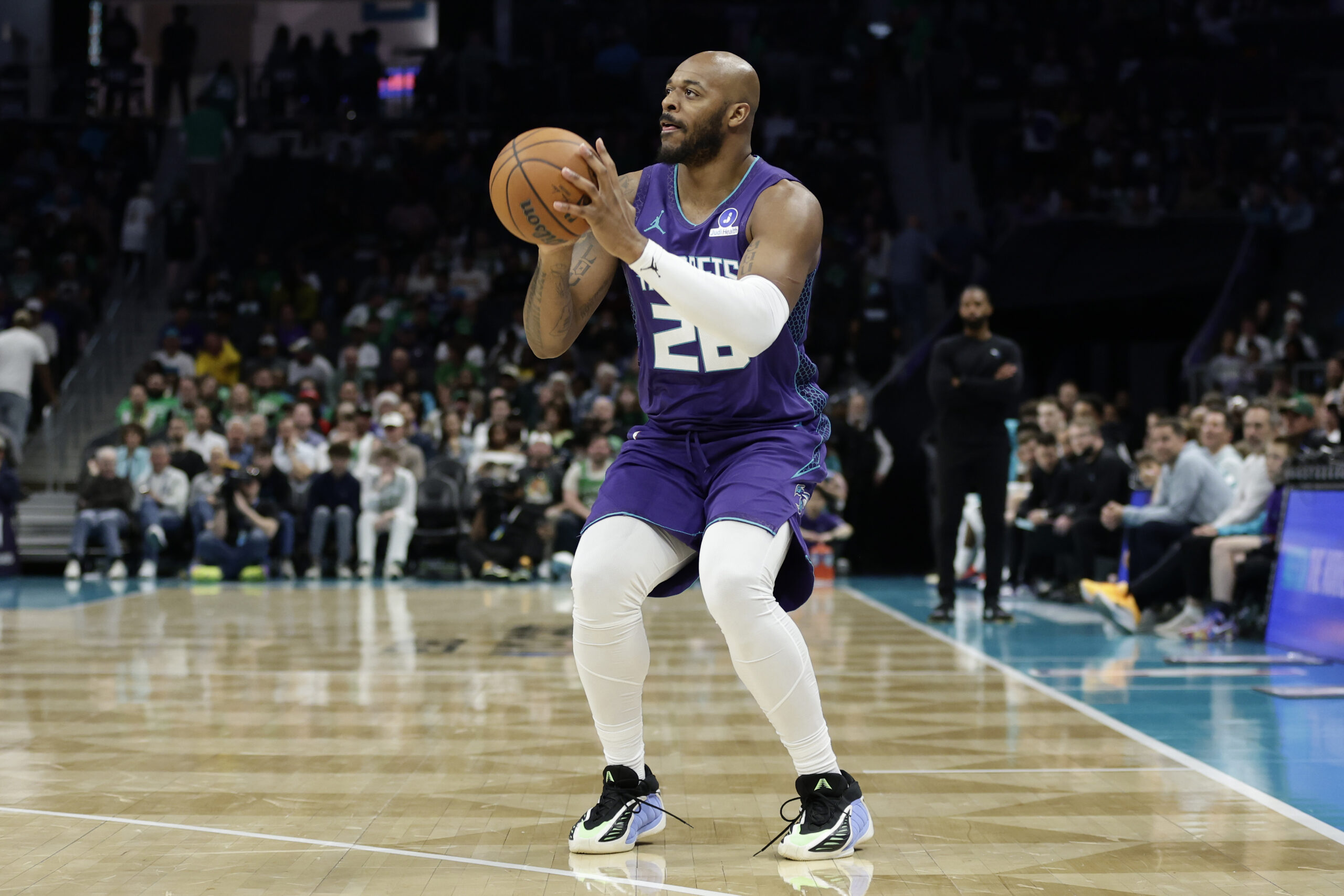 Mar 29, 2026; Charlotte, North Carolina, USA; Charlotte Hornets forward Xavier Tillman (26) prepares to attempt a three-point shot during the second half against the Boston Celtics7 at Spectrum Center. Mandatory Credit: Brian Westerholt-Imagn Images
