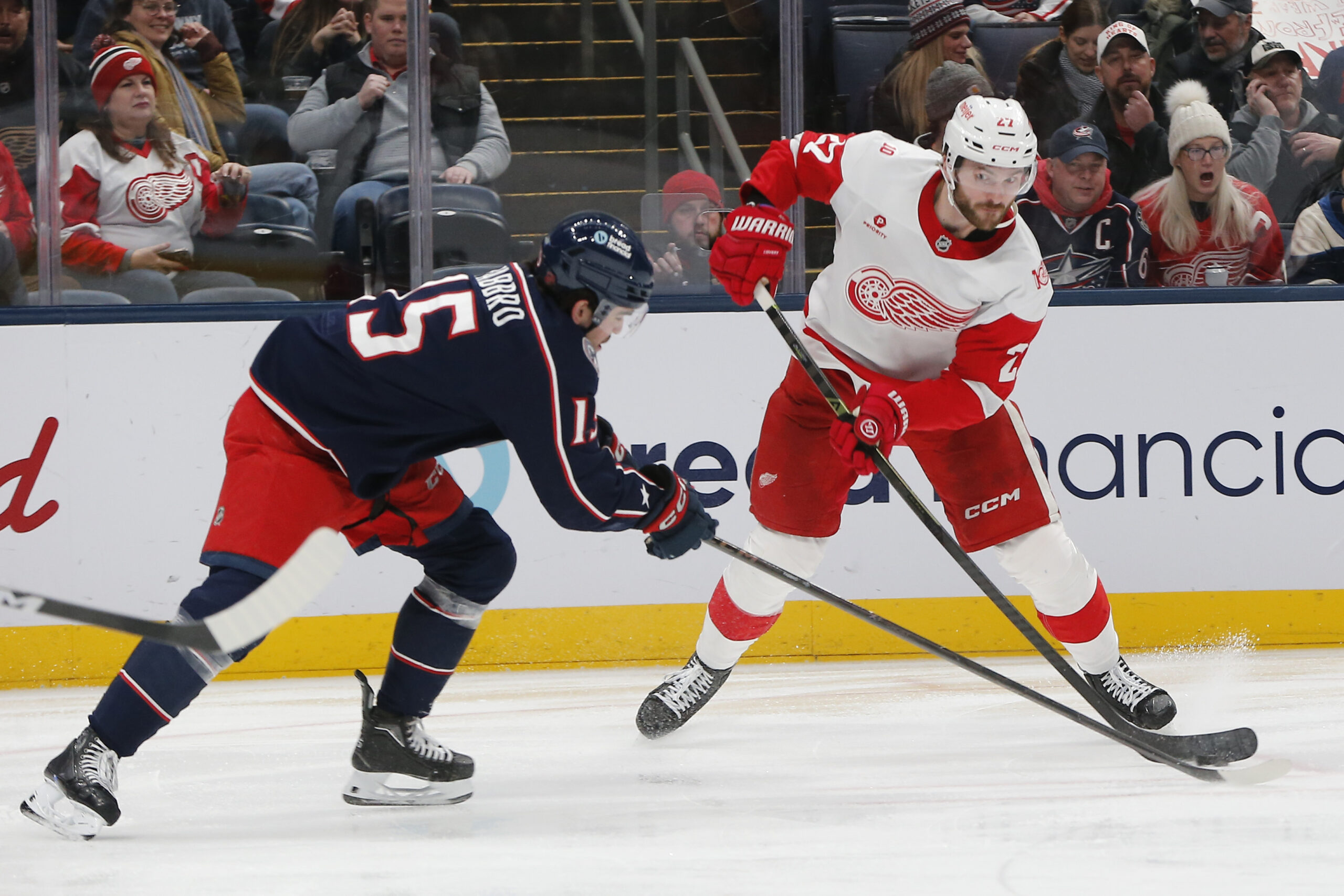 Dec 4, 2025; Columbus, Ohio, USA; Columbus Blue Jackets defenseman Dante Fabbro (15) blocks the attempt of Detroit Red Wings center Michael Rasmuss (27) during the third period at Nationwide Arena. Mandatory Credit: Russell LaBounty-Imagn Images