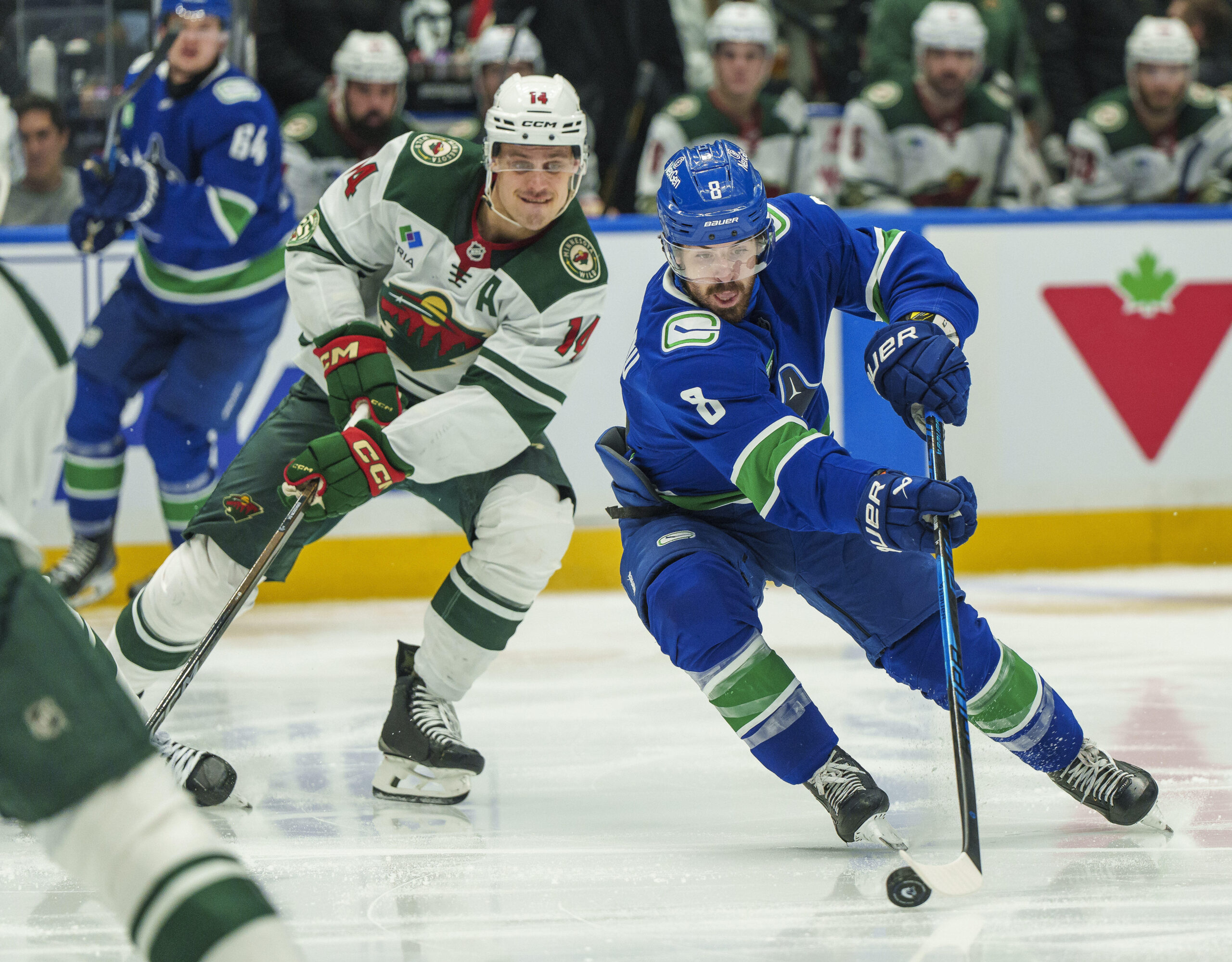 Dec 6, 2025; Vancouver, British Columbia, CAN; Vancouver Canucks left wing Conor Garland (8) gets past Minnesota Wild center Joel Eriksson Ek (14) in the third period at Rogers Arena. Mandatory Credit: Christopher Morris-Imagn Images