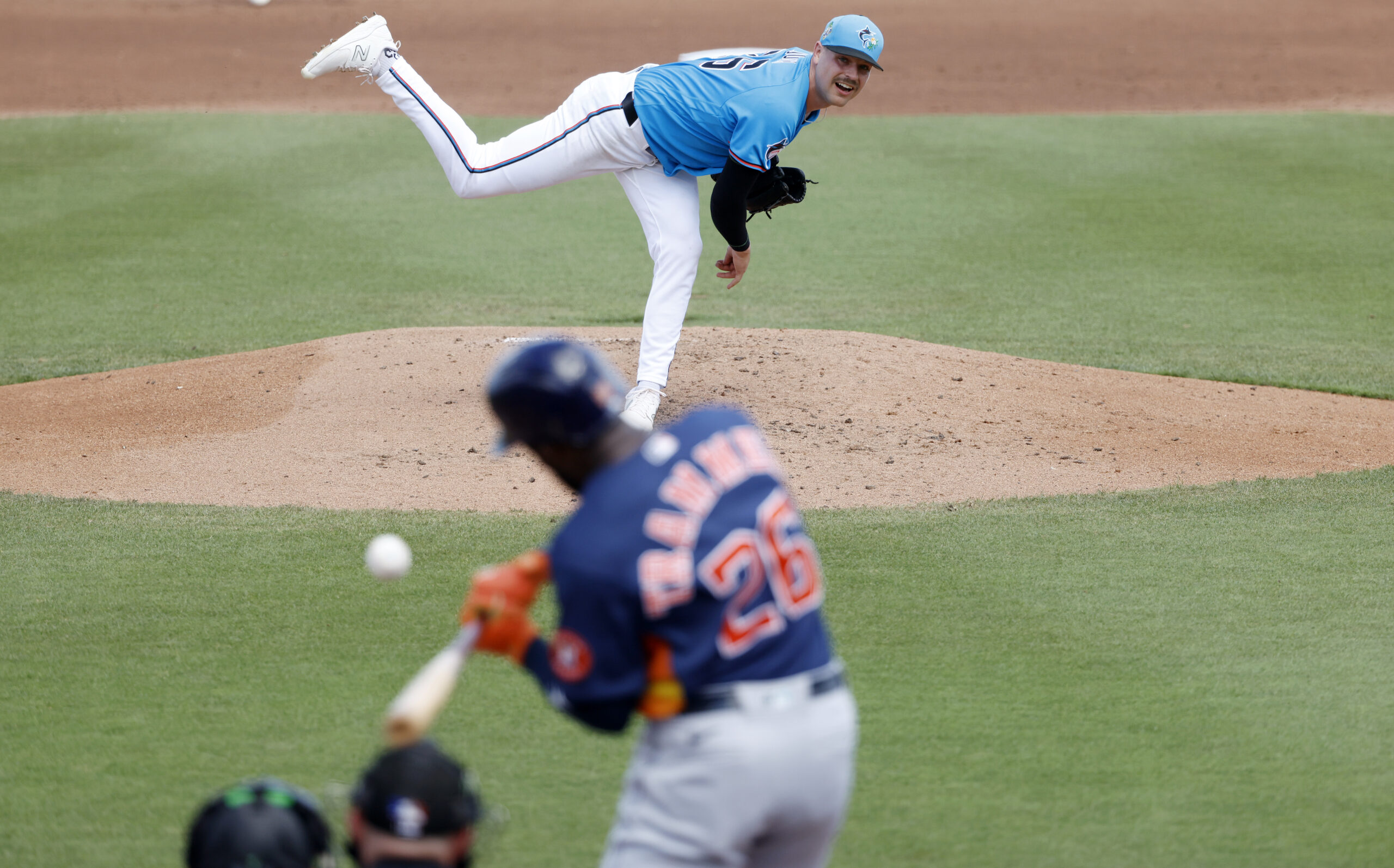 Mar 11, 2026; Jupiter, Florida, USA;  Miami Marlins pitcher Janson Junk (26) pitches to by Houston Astros left fielder Taylor Trammell during the fourth inning at Roger Dean Chevrolet Stadium. Mandatory Credit: Rhona Wise-Imagn Images