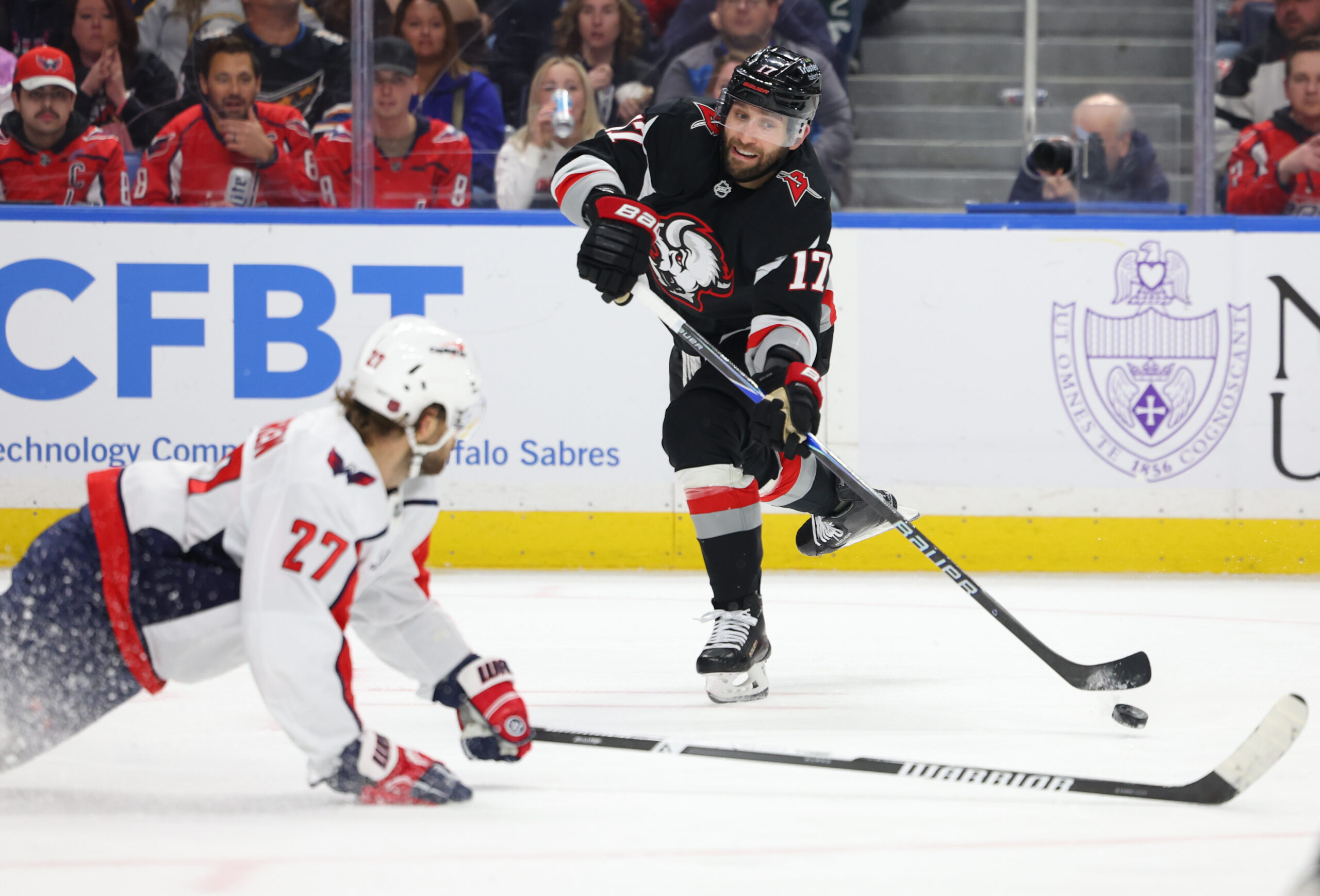 Mar 12, 2026; Buffalo, New York, USA;  Washington Capitals defenseman Timothy Liljegren (27) tries to block a shot by Buffalo Sabres left wing Jason Zucker (17) during the second period at KeyBank Center. Mandatory Credit: Timothy T. Ludwig-Imagn Images