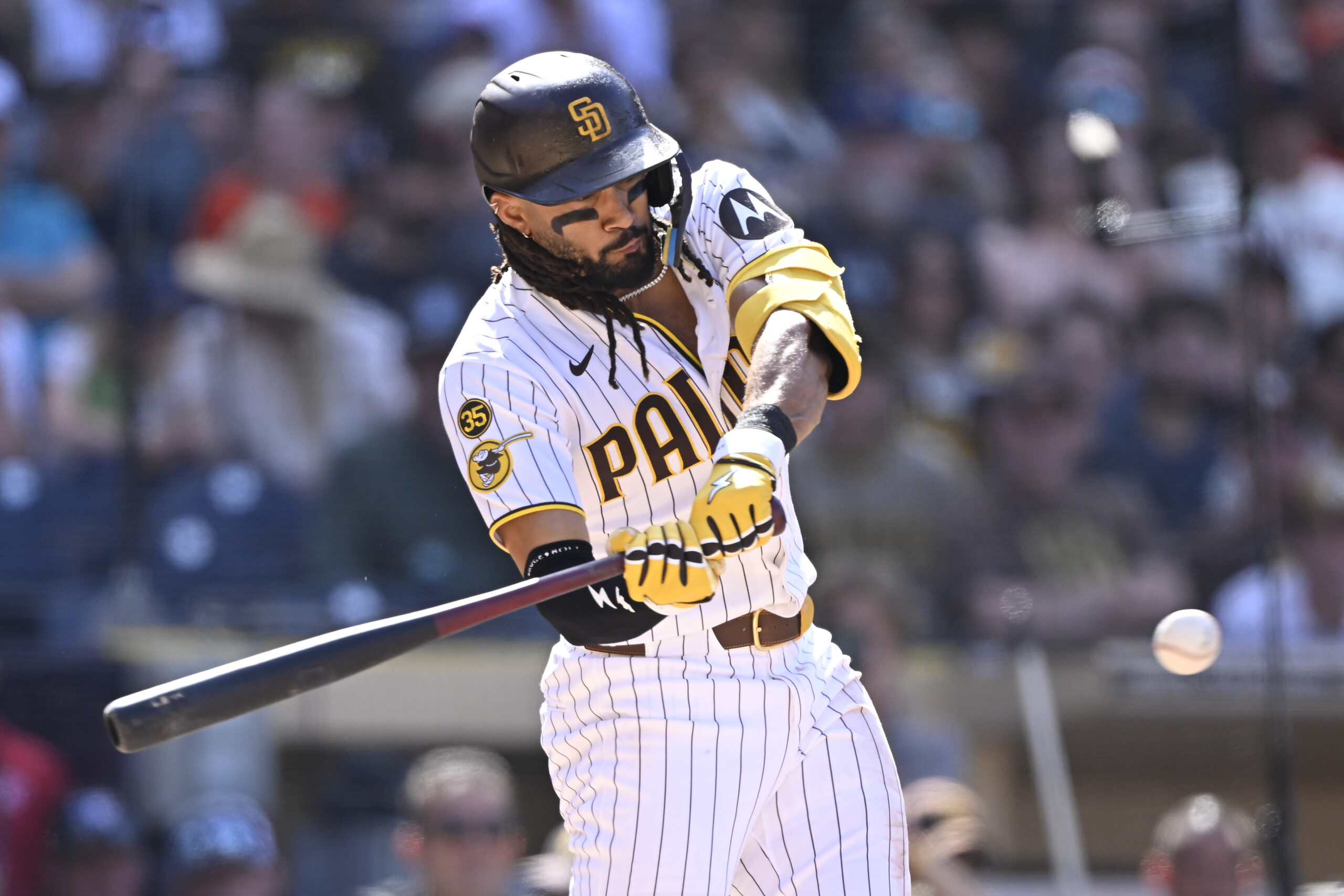 Apr 1, 2026; San Diego, California, USA; San Diego Padres right fielder Fernando Tatis Jr. (23) hits an RBI single during the eighth inning against the San Francisco Giants at Petco Park. Mandatory Credit: Denis Poroy-Imagn Images