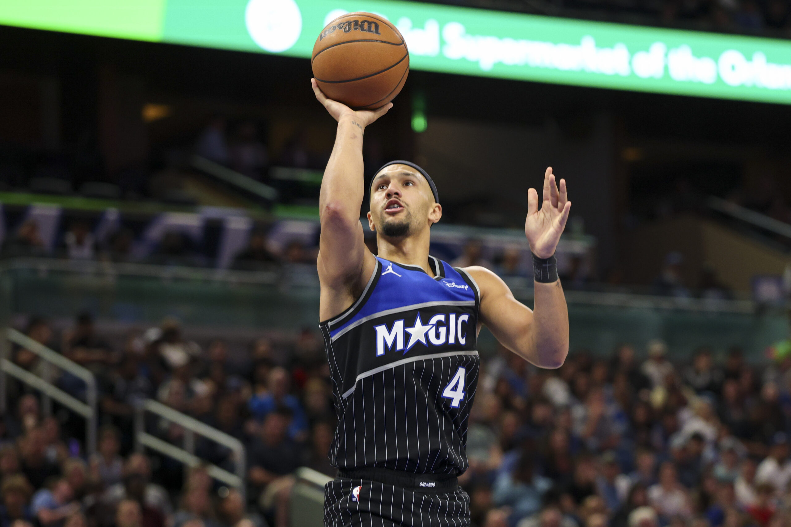 Apr 1, 2026; Orlando, Florida, USA; Orlando Magic guard Jalen Suggs (4) shoots the ball against the Atlanta Hawks in the third quarter at Kia Center. Mandatory Credit: Nathan Ray Seebeck-Imagn Images