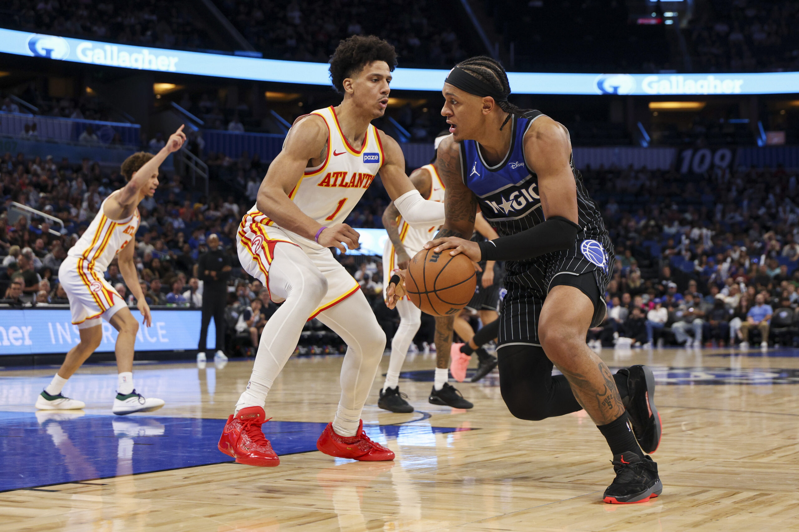 Apr 1, 2026; Orlando, Florida, USA; Orlando Magic forward Paolo Banchero (5) is guarded by Atlanta Hawks forward Jalen Johnson (1) in the third quarter at Kia Center. Mandatory Credit: Nathan Ray Seebeck-Imagn Images