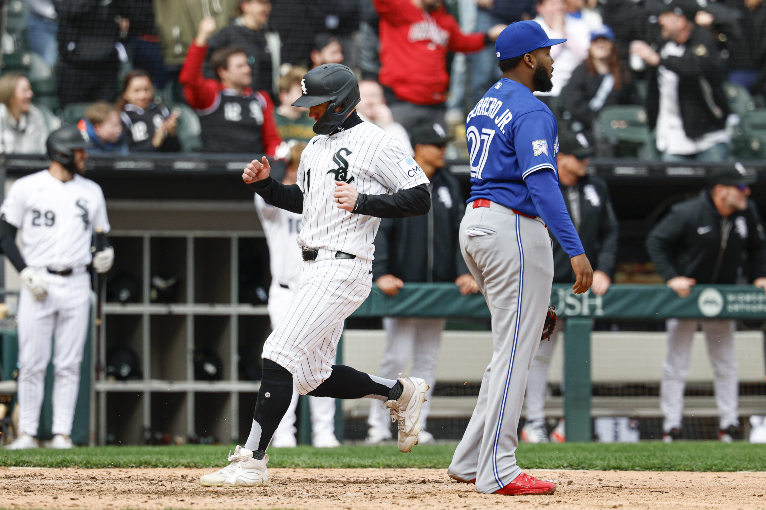 Apr 4, 2026; Chicago, Illinois, USA; Chicago White Sox left fielder Austin Hays (21) scores against the Toronto Blue Jays during the eight inning at Rate Field. Mandatory Credit: Kamil Krzaczynski-Imagn Images