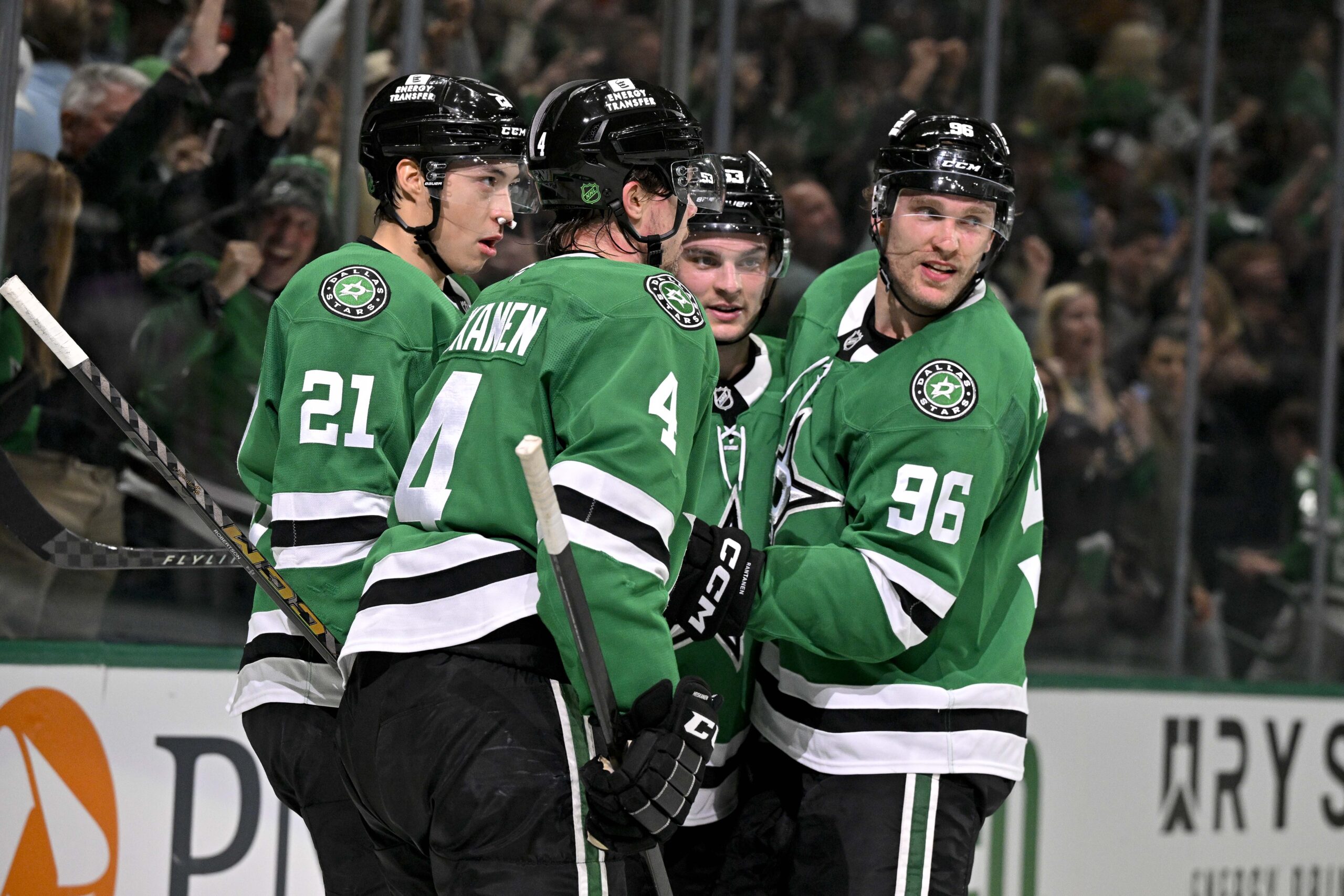 Apr 7, 2026; Dallas, Texas, USA; Dallas Stars defenseman Miro Heiskanen (4) and left wing Jason Robertson (21) and center Wyatt Johnston (53) and right wing Mikko Rantanen (96) celebrate after Johnston scores the game winning power-play goal against Calgary Flames goaltender Devin Cooley (not pictured) during the overtime period at the American Airlines Center. Mandatory Credit: Jerome Miron-Imagn Images