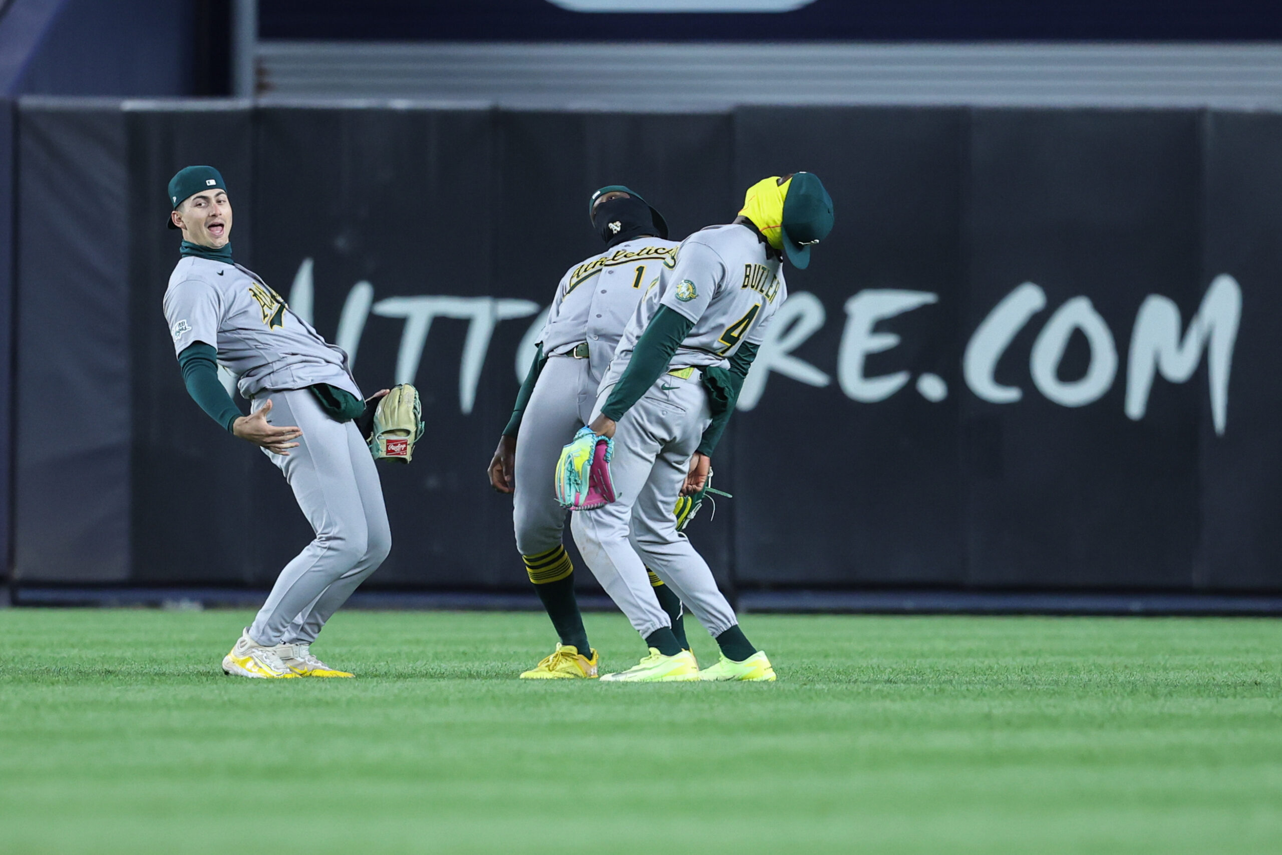 Apr 8, 2026; Bronx, New York, USA;  Athletics outfielders Athletics left fielder Tyler Soderstrom (21), Denzel Clarke (1) and Lawrence Butler (4) celebrate after defeating the New York Yankees 3-2 at Yankee Stadium. Mandatory Credit: Wendell Cruz-Imagn Images