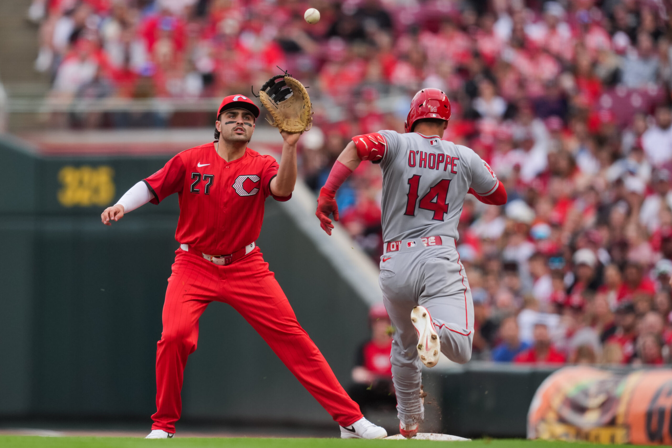 Apr 11, 2026; Cincinnati, Ohio, USA;  Cincinnati Reds third baseman Sal Stewart (27) fields the ball as Los Angeles Angels catcher Logan O'Hoppe (14) attempts to run to first base after striking out in the eighth inning at Great American Ball Park. Logan O’Hoppe was called out for batter interference. Mandatory Credit: Aaron Doster-Imagn Images