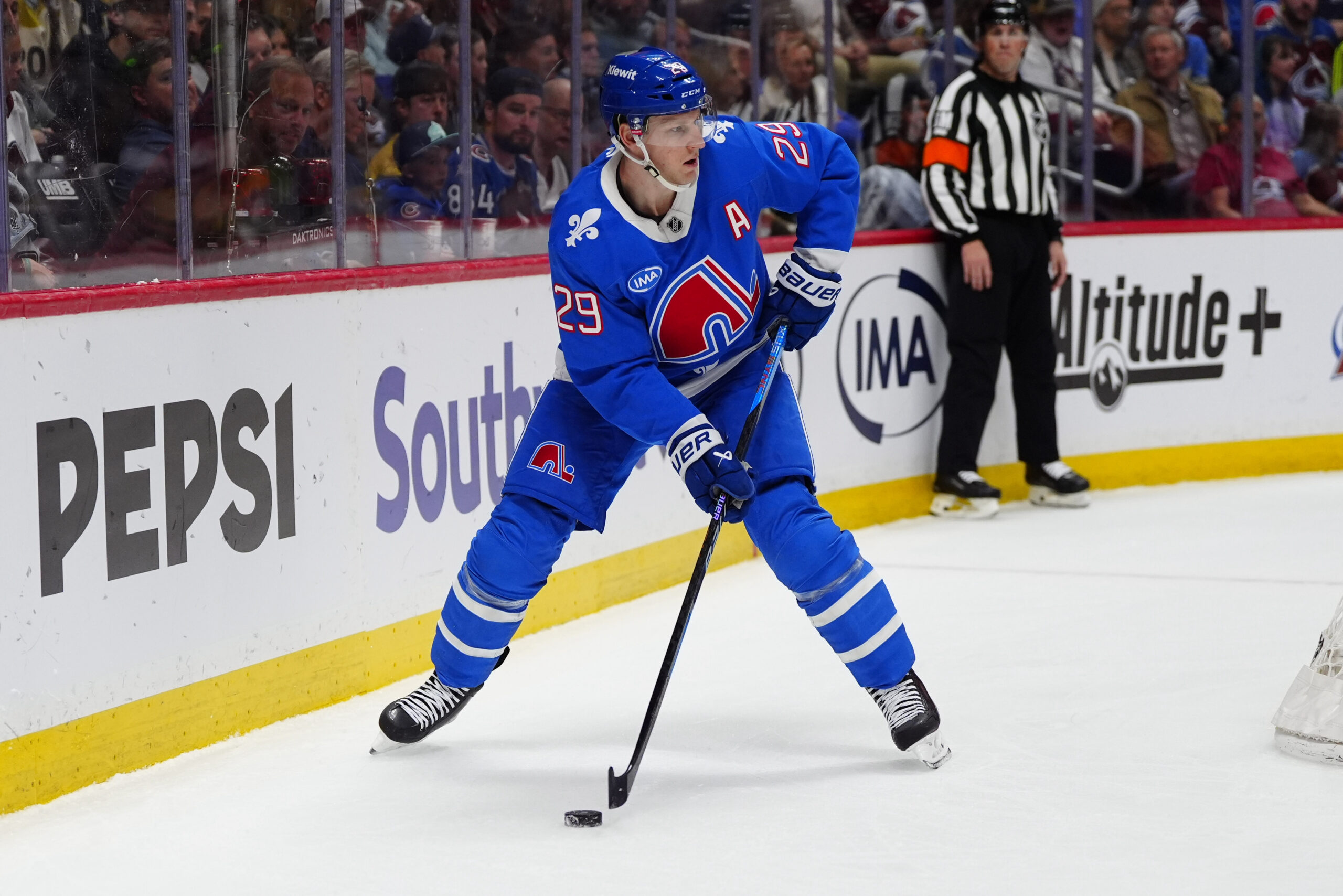 Apr 11, 2026; Denver, Colorado, USA; Colorado Avalanche center Nathan MacKinnon (29) controls the puck in the second period against the Vegas Golden Knights  at Ball Arena. Mandatory Credit: Ron Chenoy-Imagn Images