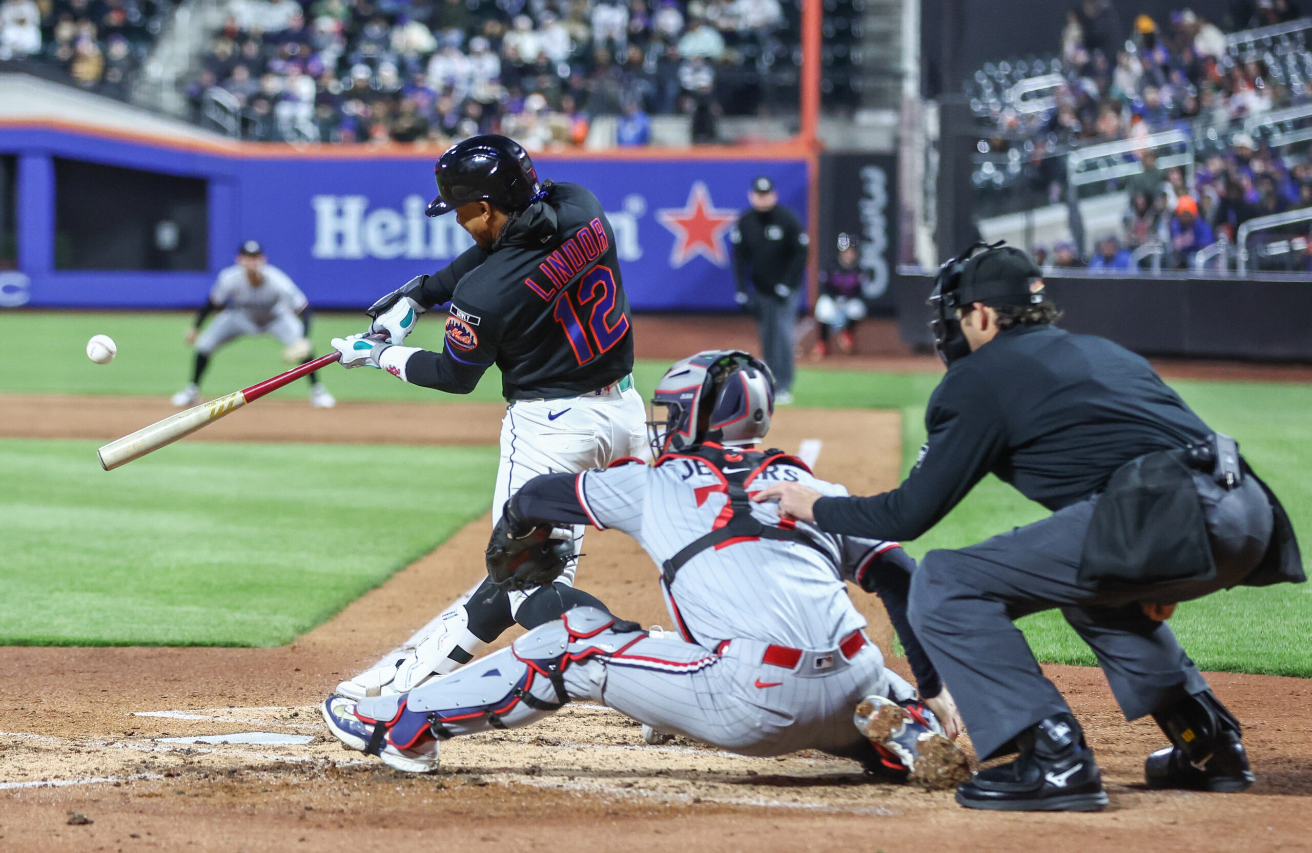 Apr 21, 2026; New York City, New York, USA;  New York Mets shortstop Francisco Lindor (12) hits a three-run home run in the third inning against the Minnesota Twins at Citi Field. Mandatory Credit: Wendell Cruz-Imagn Images