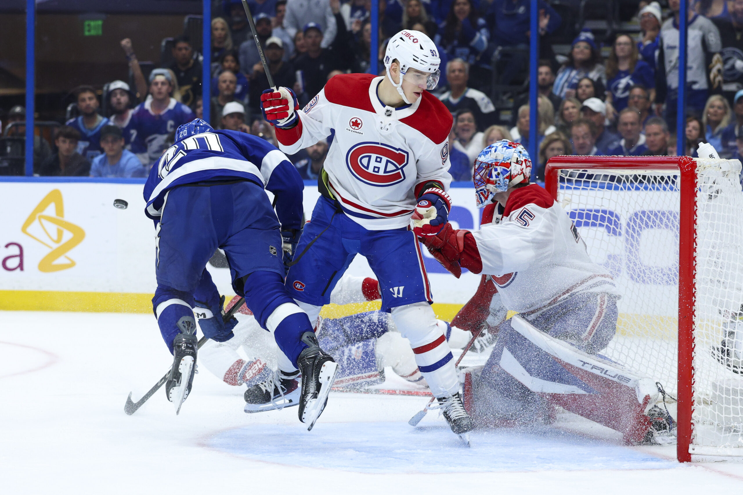 Apr 21, 2026; Tampa, Florida, USA; Tampa Bay Lightning left wing Nick Paul (20) is tipped up in front of the goal by Montreal Canadiens right wing Ivan Demidov (93) in the third period during game two of the first round of the 2026 Stanley Cup Playoffs at Benchmark International Arena. Mandatory Credit: Nathan Ray Seebeck-Imagn Images