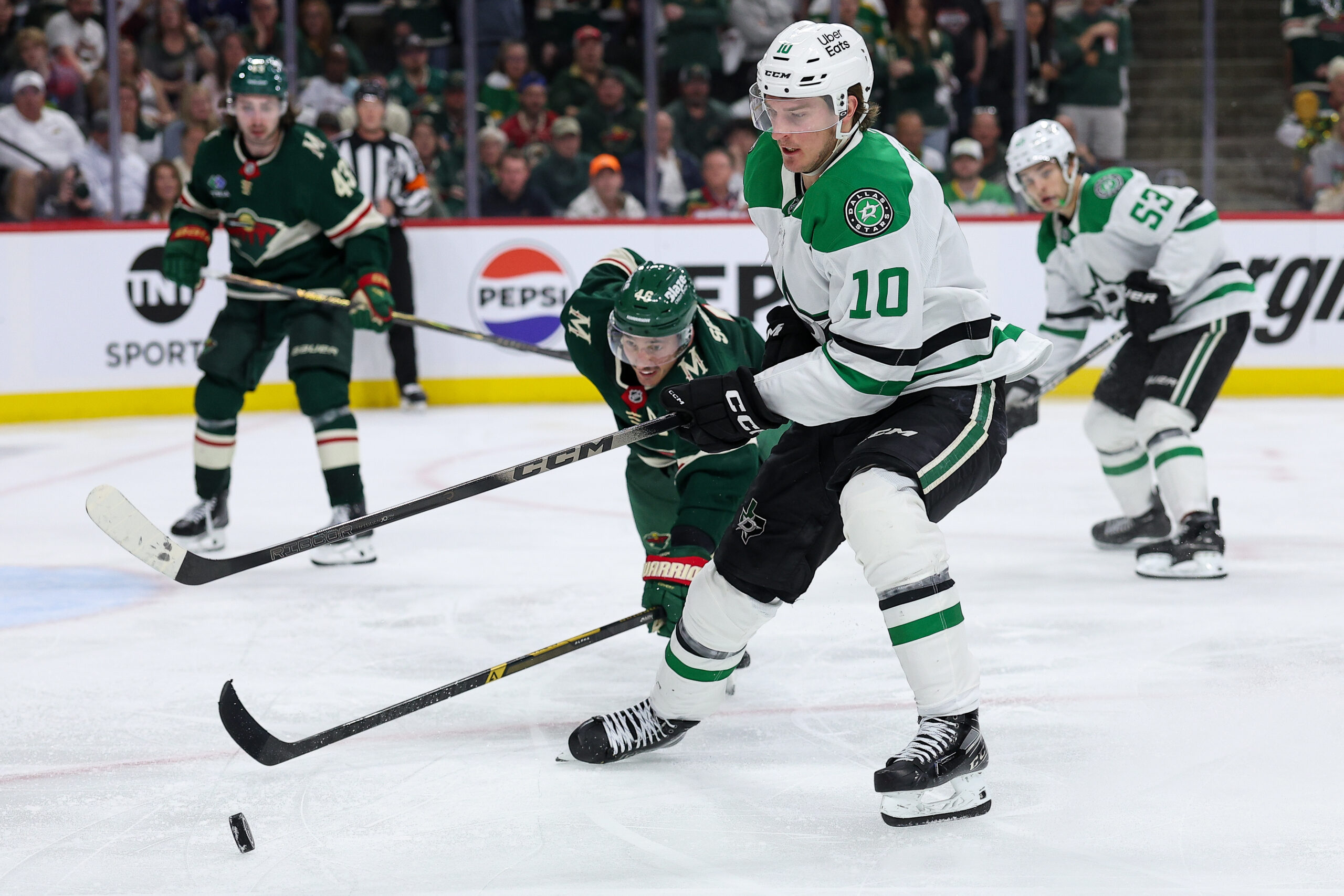 Apr 22, 2026; Saint Paul, Minnesota, USA; Dallas Stars center Oskar Back (10) and Minnesota Wild defenseman Jared Spurgeon (46) compete for the puck during the first overtime period in game three of the first round of the 2026 Stanley Cup Playoffs at Grand Casino Arena. Mandatory Credit: Matt Krohn-Imagn Images