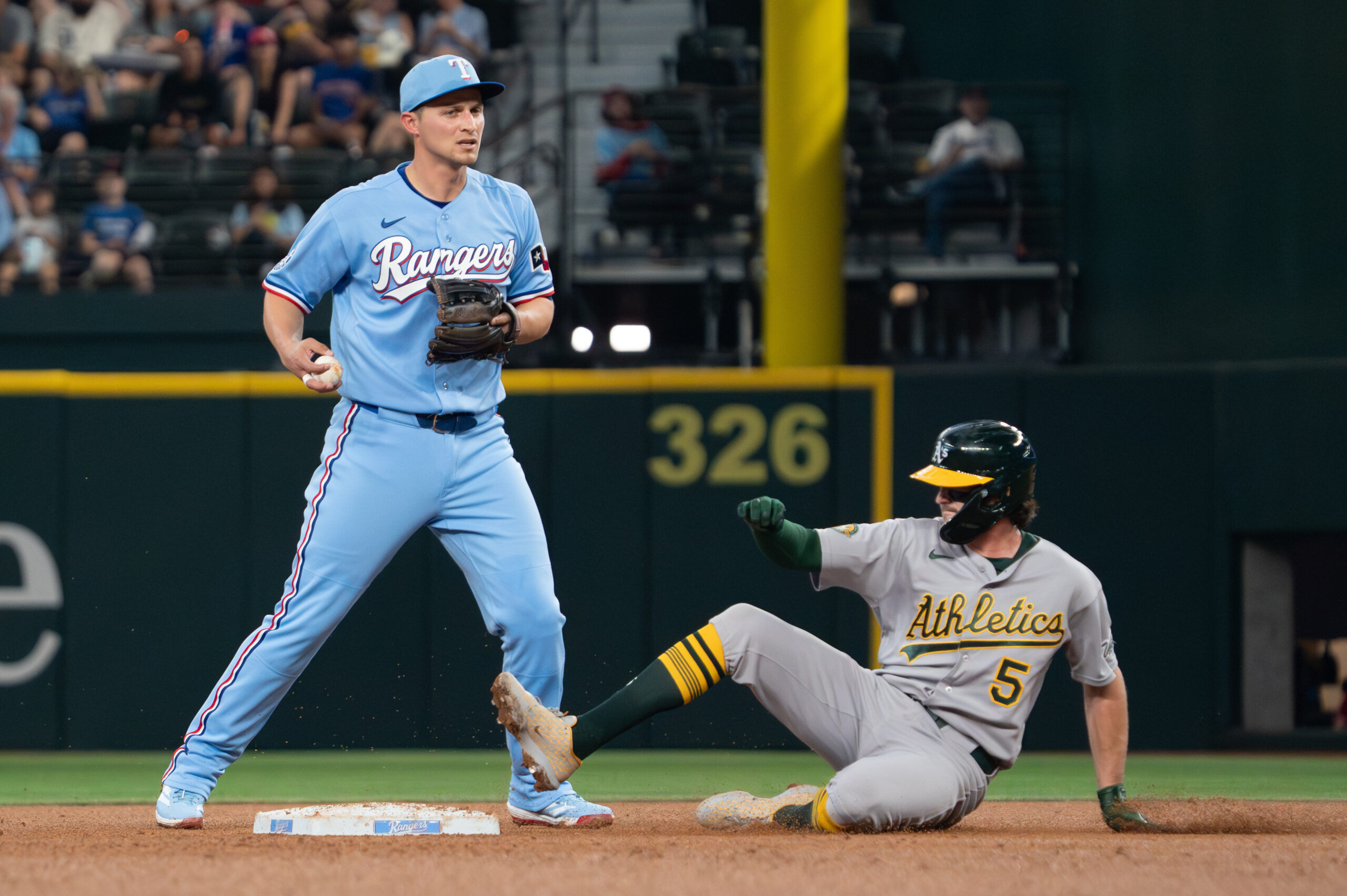 Apr 26, 2026; Arlington, Texas, USA; Texas Rangers shortstop Corey Seager (5) forces Athletics shortstop Jacob Wilson (5) out at second base during the fourth inning at Globe Life Field. Mandatory Credit: Raymond Carlin III-Imagn Images