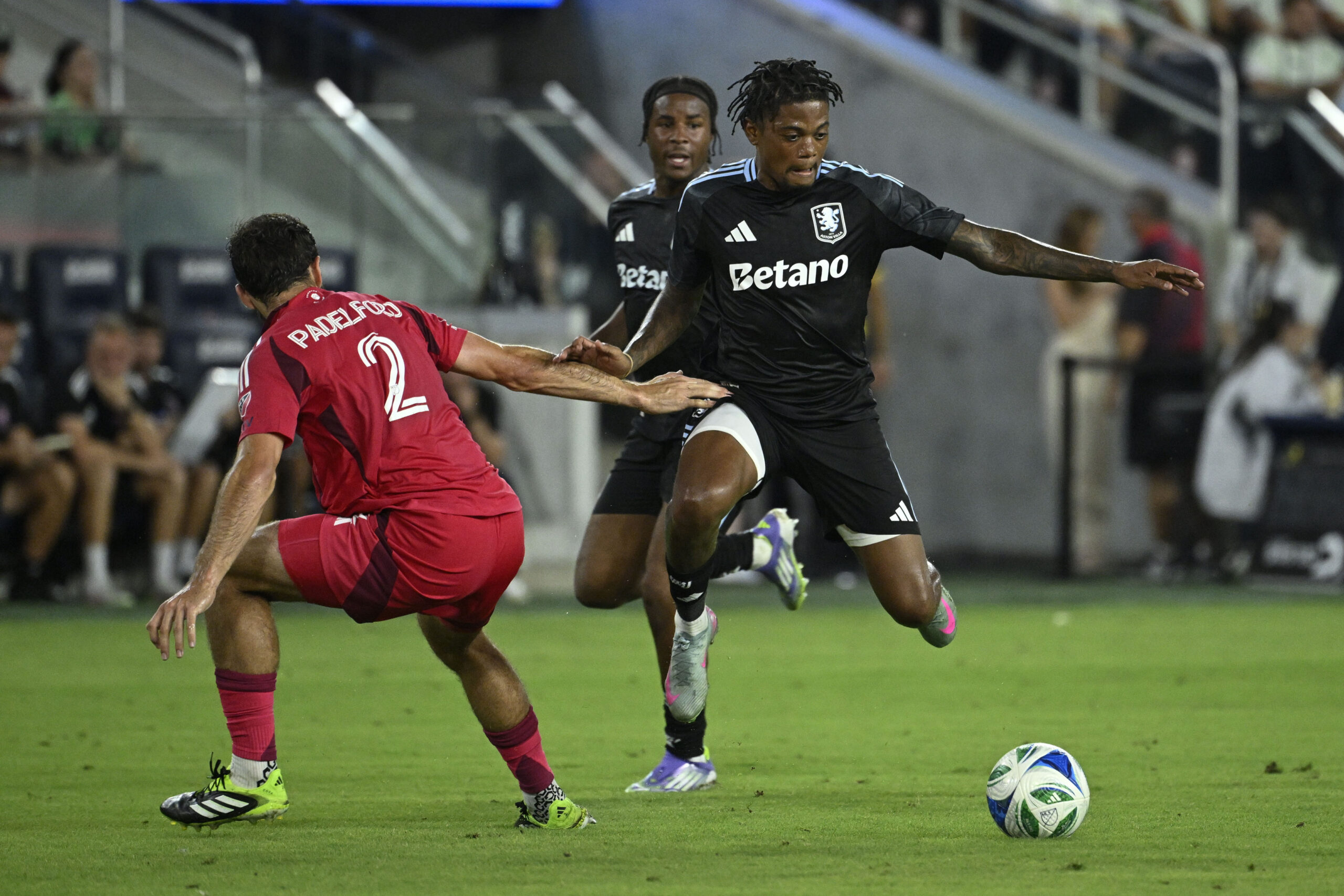 Jul 30, 2025; St. Louis, Missouri, USA; St. Louis City defender Devin Padelford (2) defends against Aston Villa midfielder Leon Bailey (31) in the first half at Energizer Park. Mandatory Credit: Joe Puetz-Imagn Images