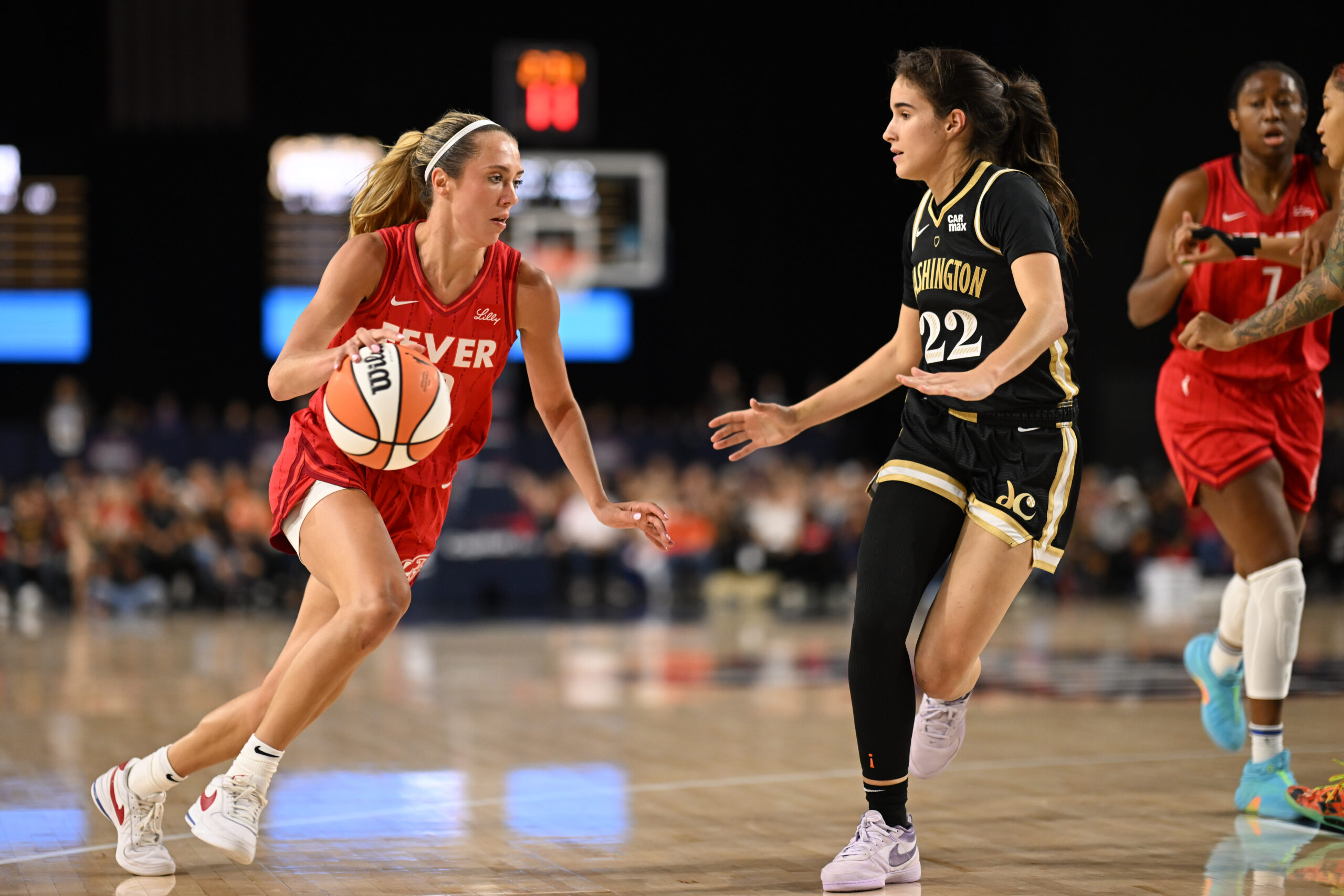 Sep 7, 2025; Baltimore, MD, USA; Indiana Fever guard Lexie Hull (10) attempts to drive past Washington Mystics guard Sonia Citron (22) during the first quarter at CFG Bank Arena. Mandatory Credit: Rafael Suanes-Imagn Images