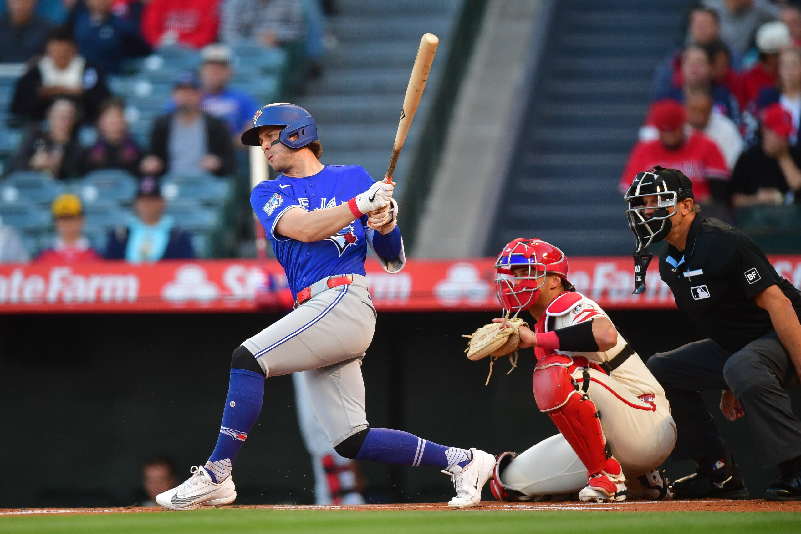 Apr 21, 2026; Anaheim, California, USA; Toronto Blue Jays second baseman Ernie Clement (22) hits a single against the Los Angeles Angels during the first inning at Angel Stadium. Mandatory Credit: Gary A. Vasquez-Imagn Images