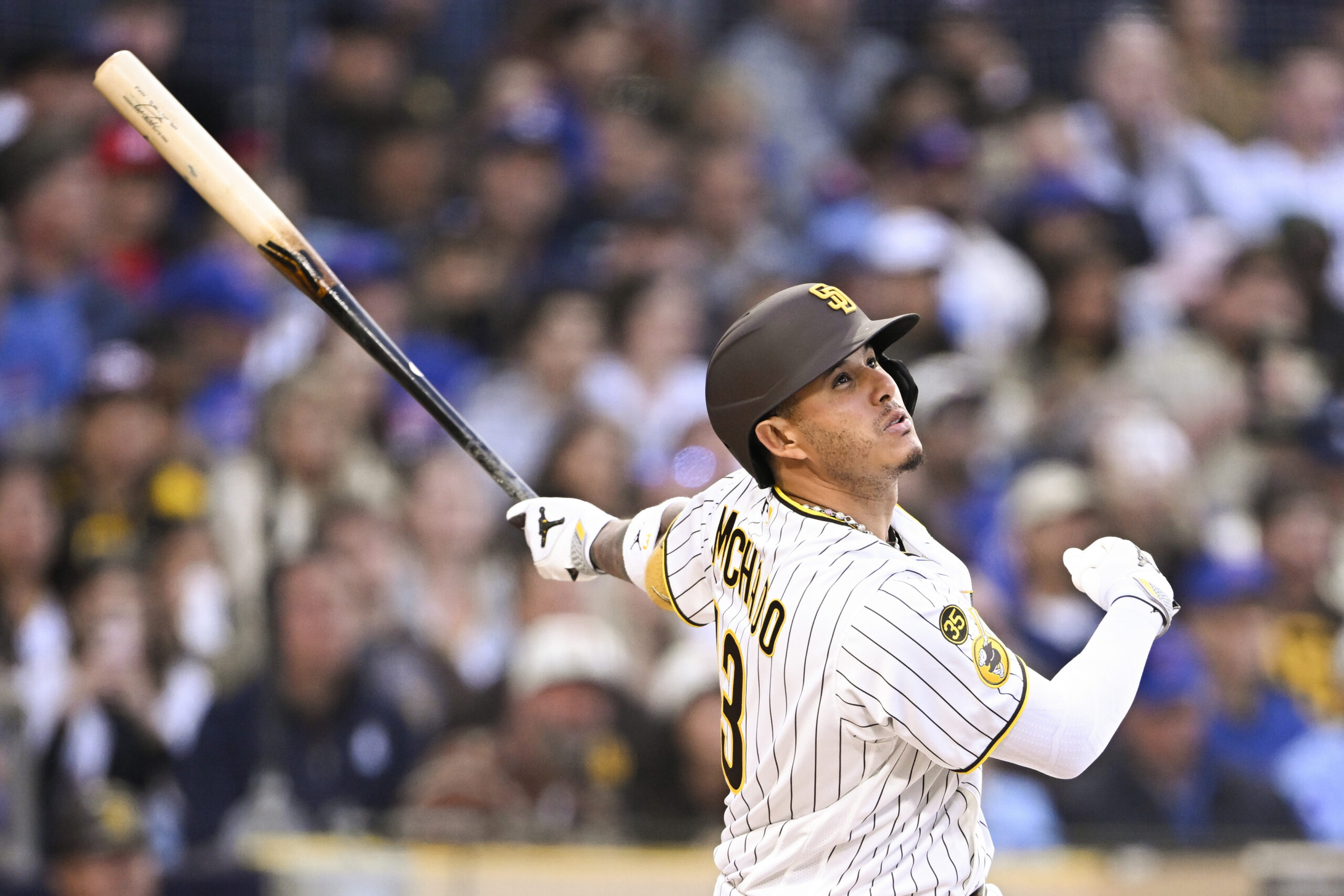 Apr 27, 2026; San Diego, California, USA; San Diego Padres third baseman Manny Machado (13) hits a single during the first inning against the Chicago Cubs at Petco Park. Mandatory Credit: Denis Poroy-Imagn Images