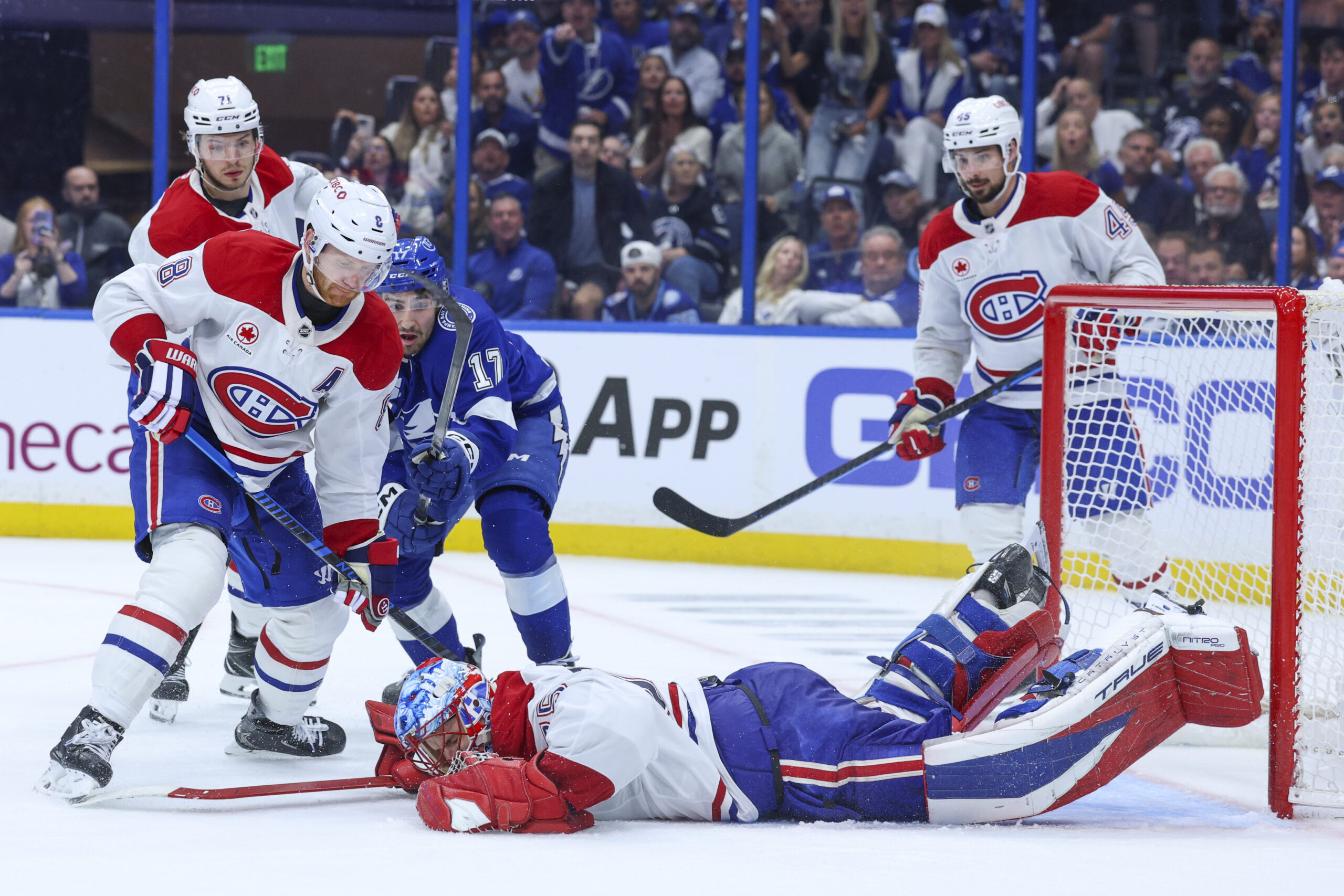 Apr 29, 2026; Tampa, Florida, USA; Montreal Canadiens goaltender Jakub Dobes (75) dives on the puck against the Tampa Bay Lightning in the third period during game five of the first round of the 2026 Stanley Cup Playoffs at Benchmark International Arena. Mandatory Credit: Nathan Ray Seebeck-Imagn Images
